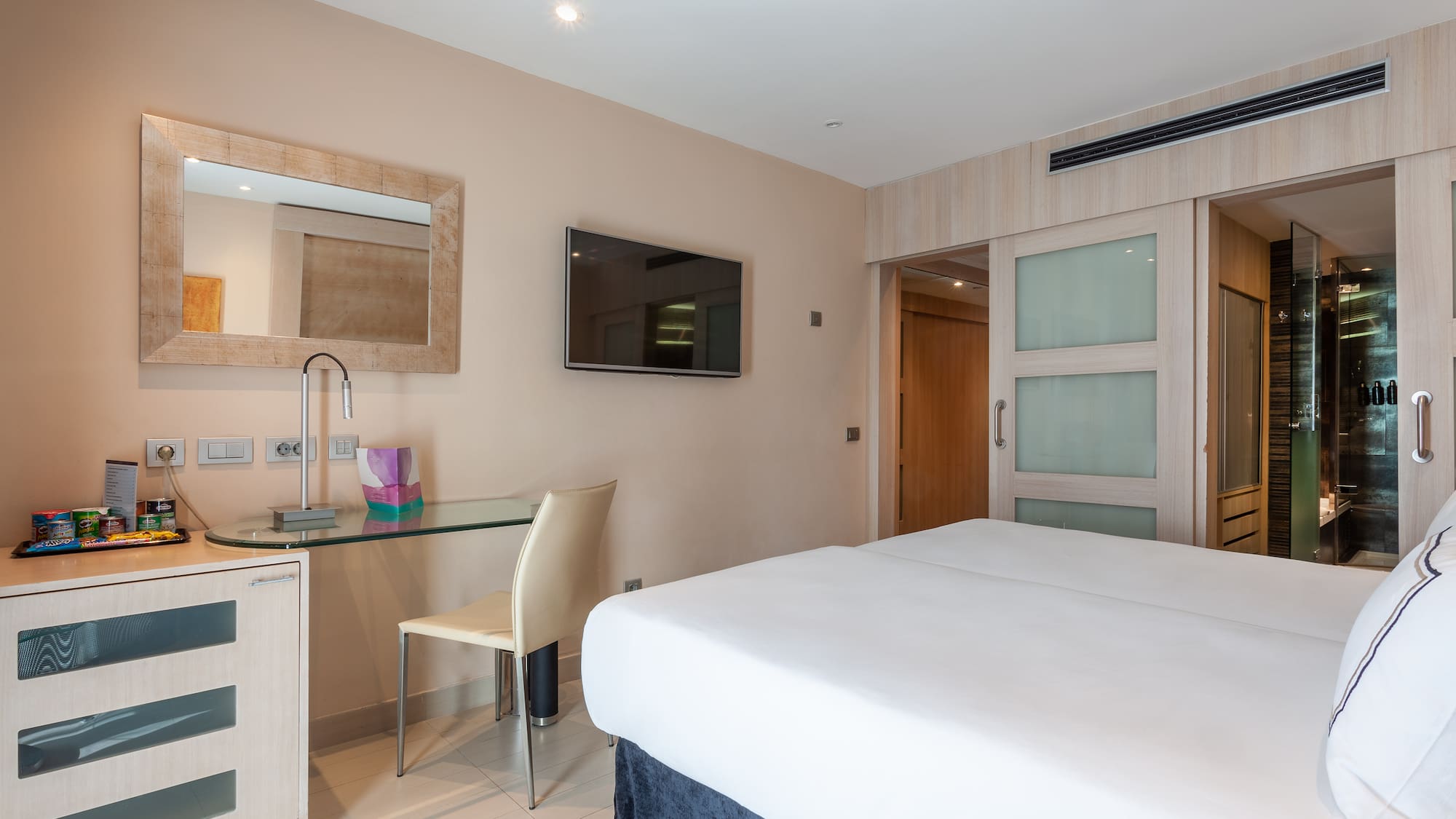 a room with a bed and a desk