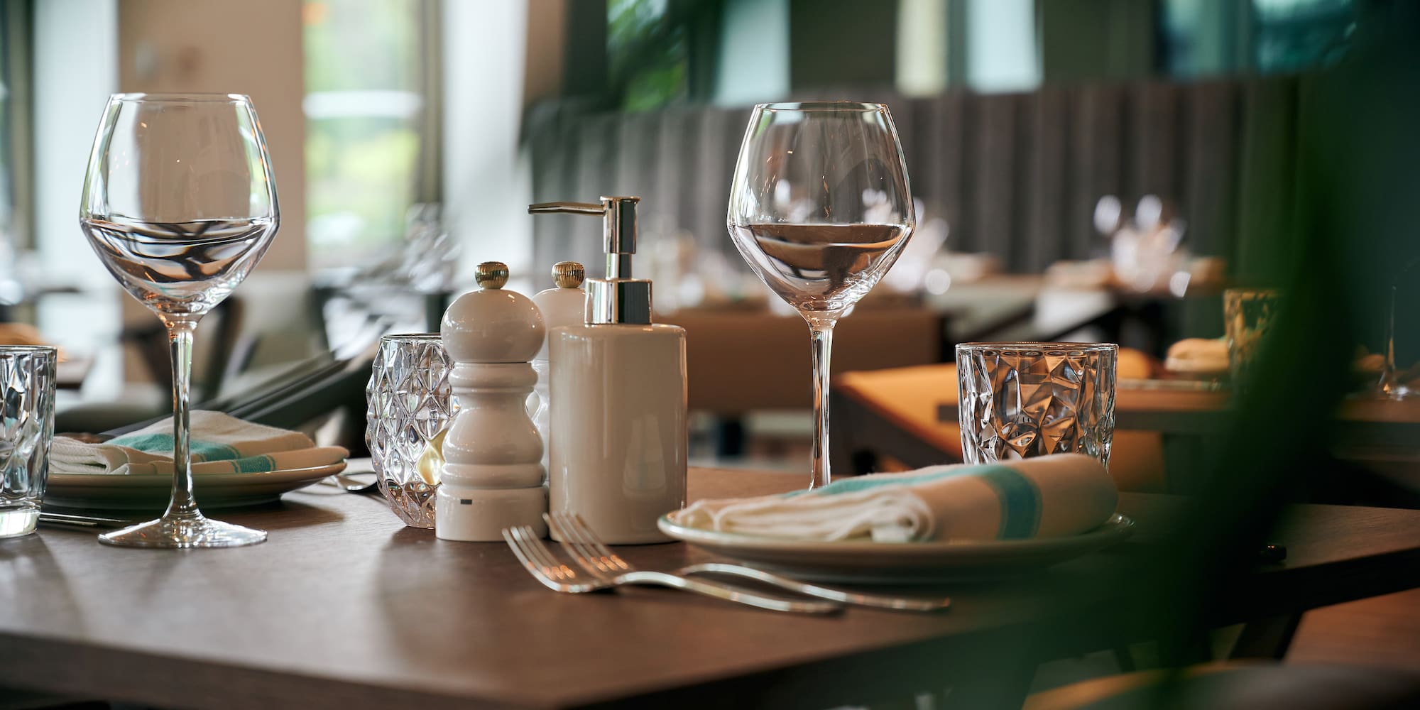 a table with a lot of wine glasses and a plate