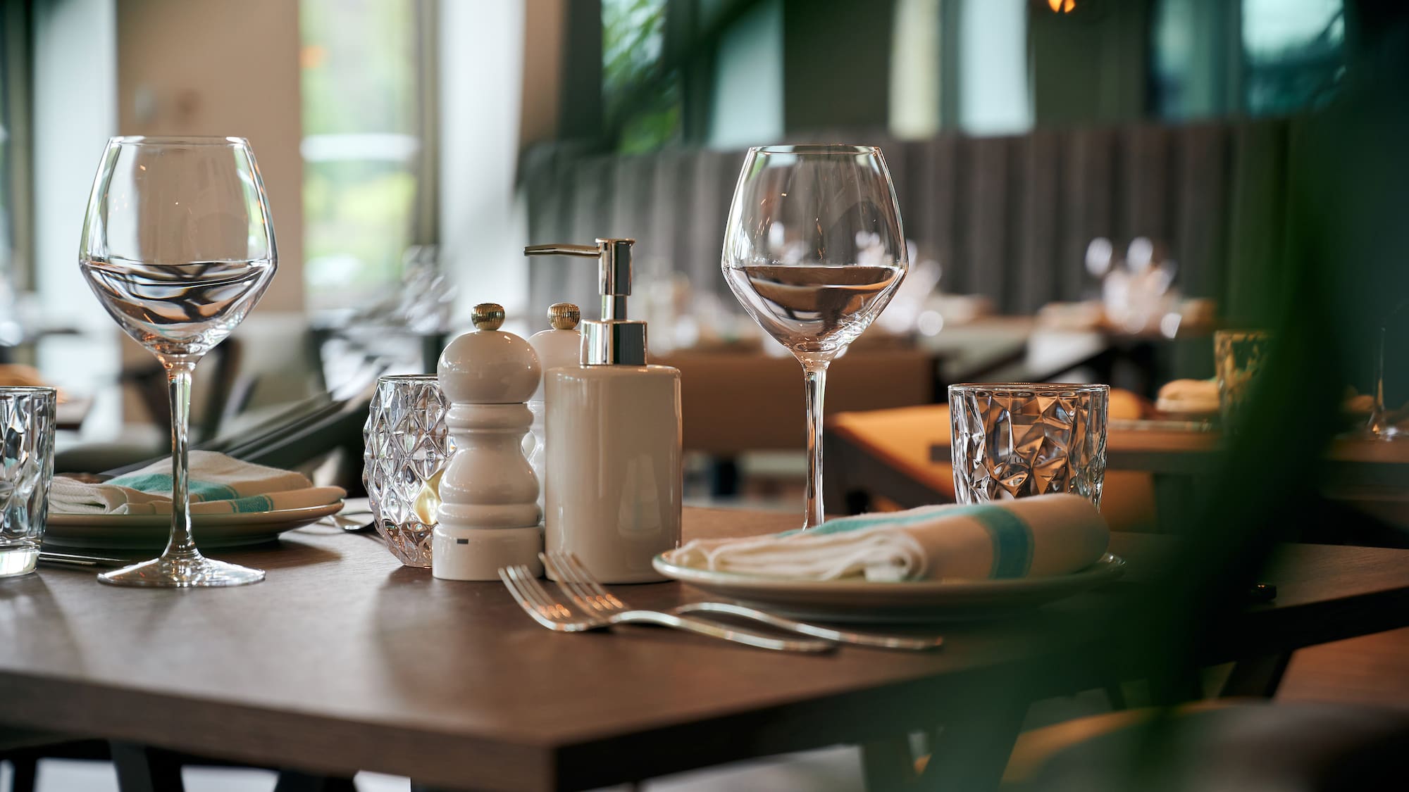 a table with a lot of wine glasses and a plate