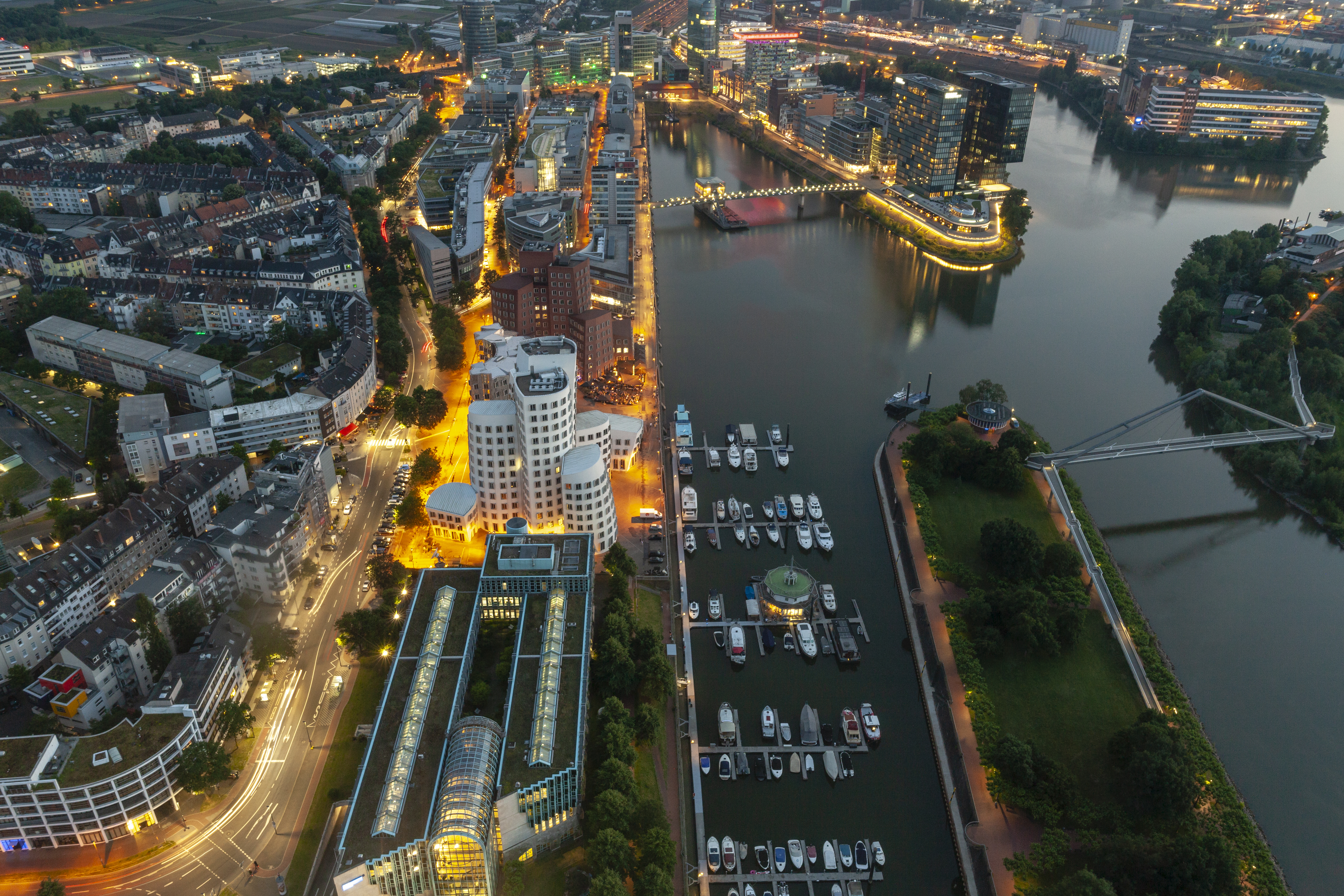 Düsseldorf Media Harbour at night, illuminated modern cityscape with marina.