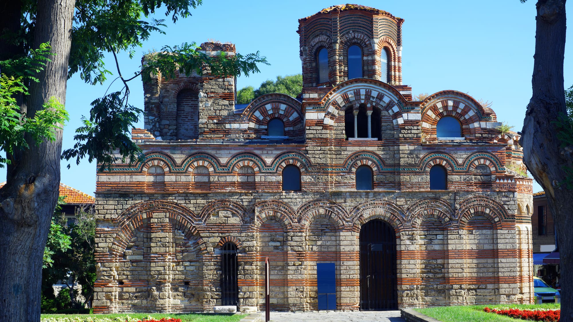 a stone building with a stone structure with Nesebar in the background