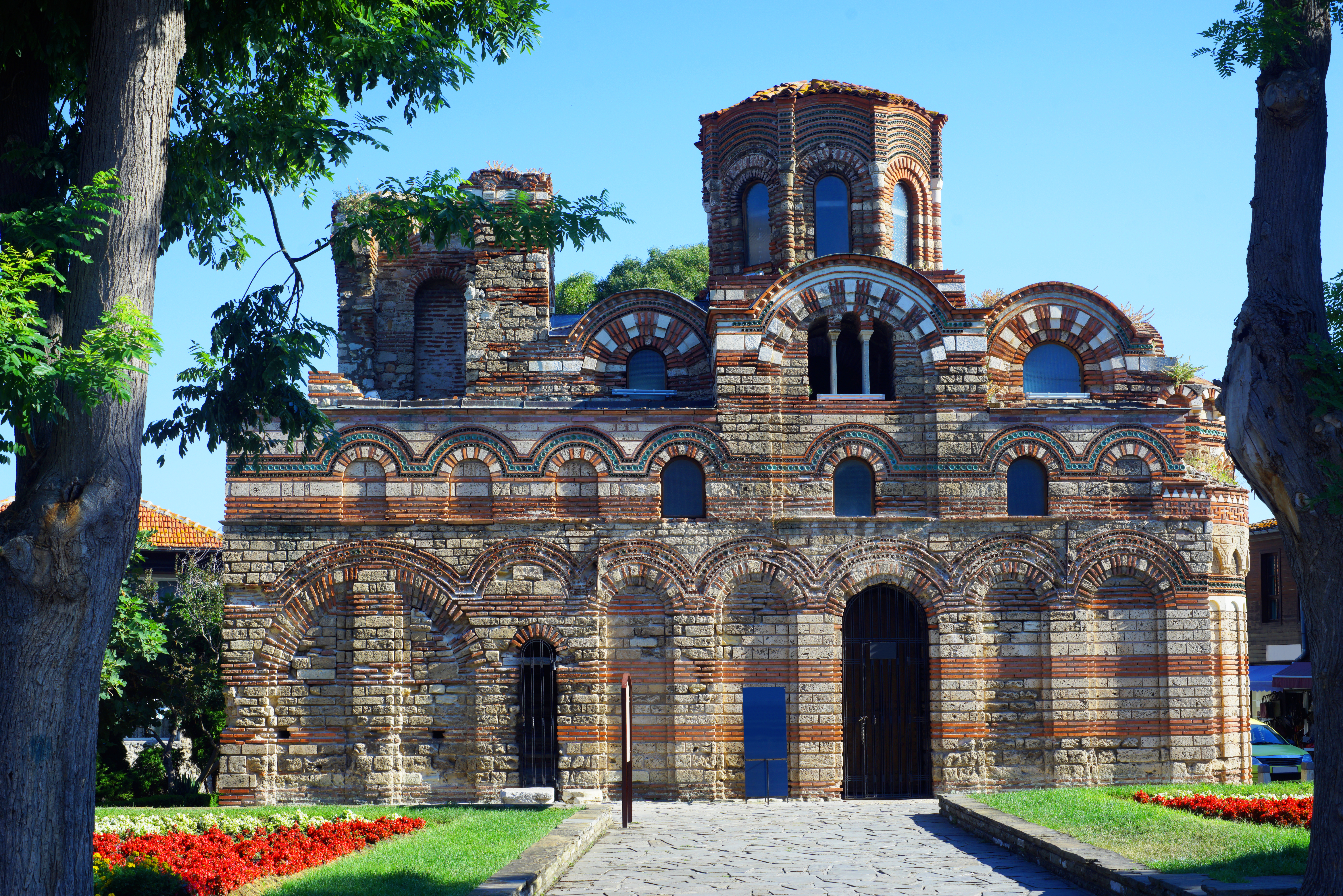 a stone building with a stone structure with Nesebar in the background