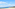 a beach with trees and mountains in the background