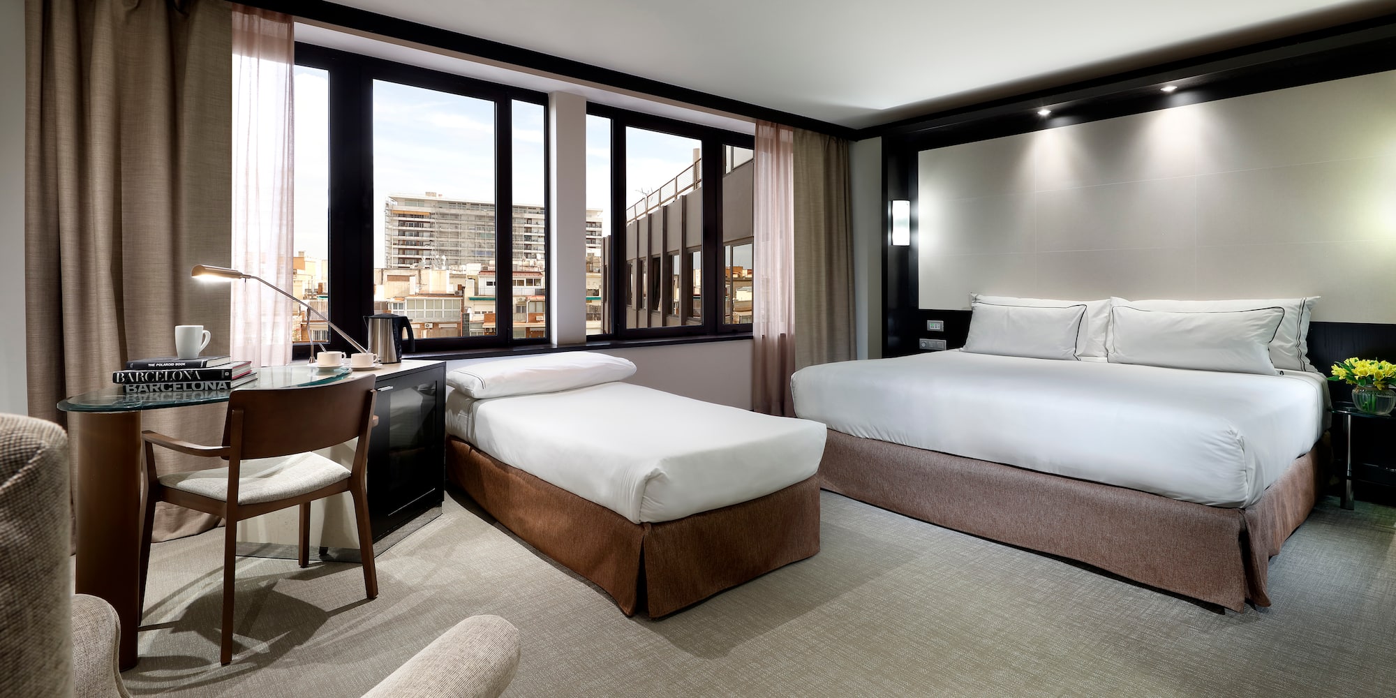 a room with two beds and a desk