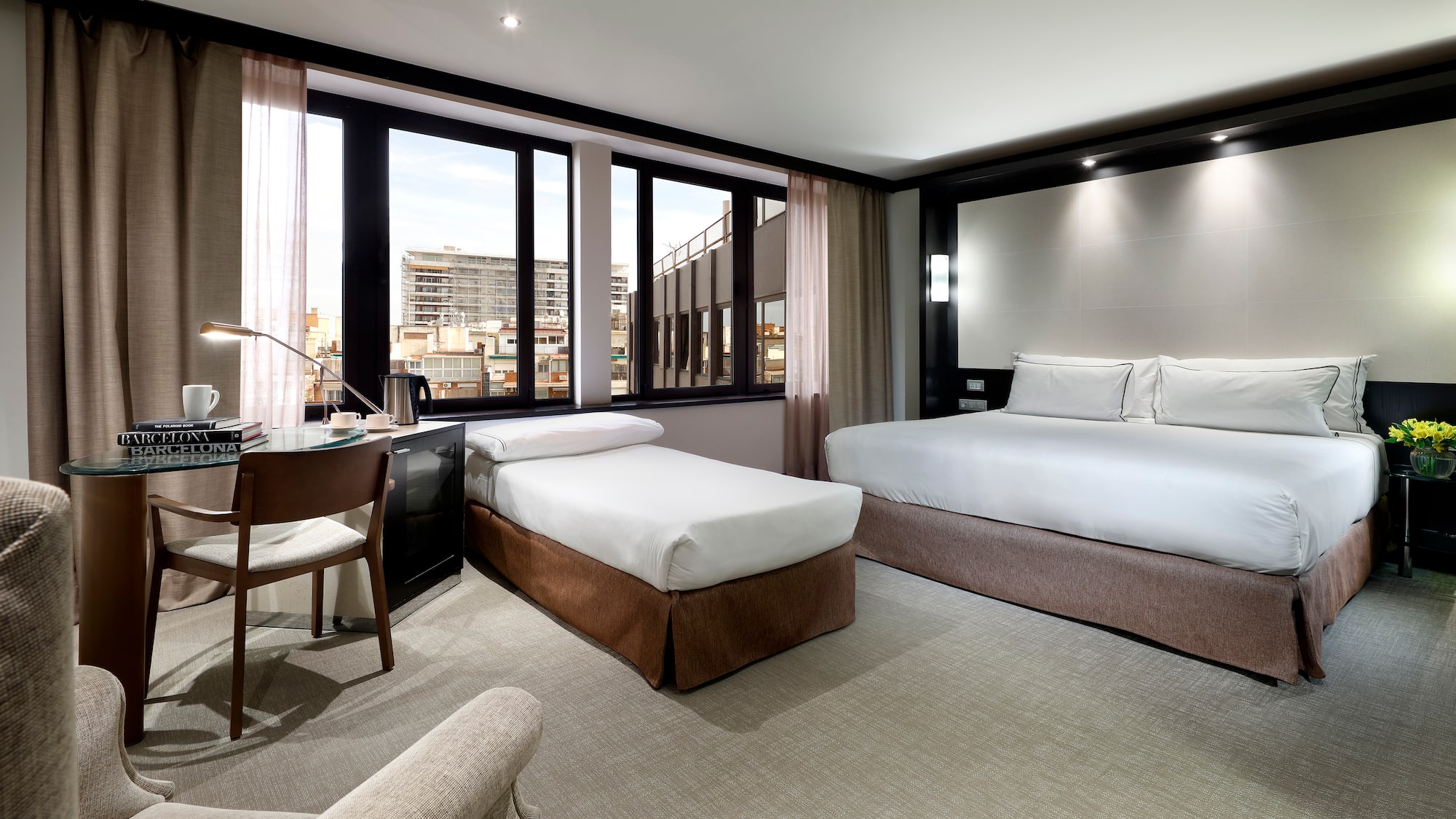 a room with two beds and a desk