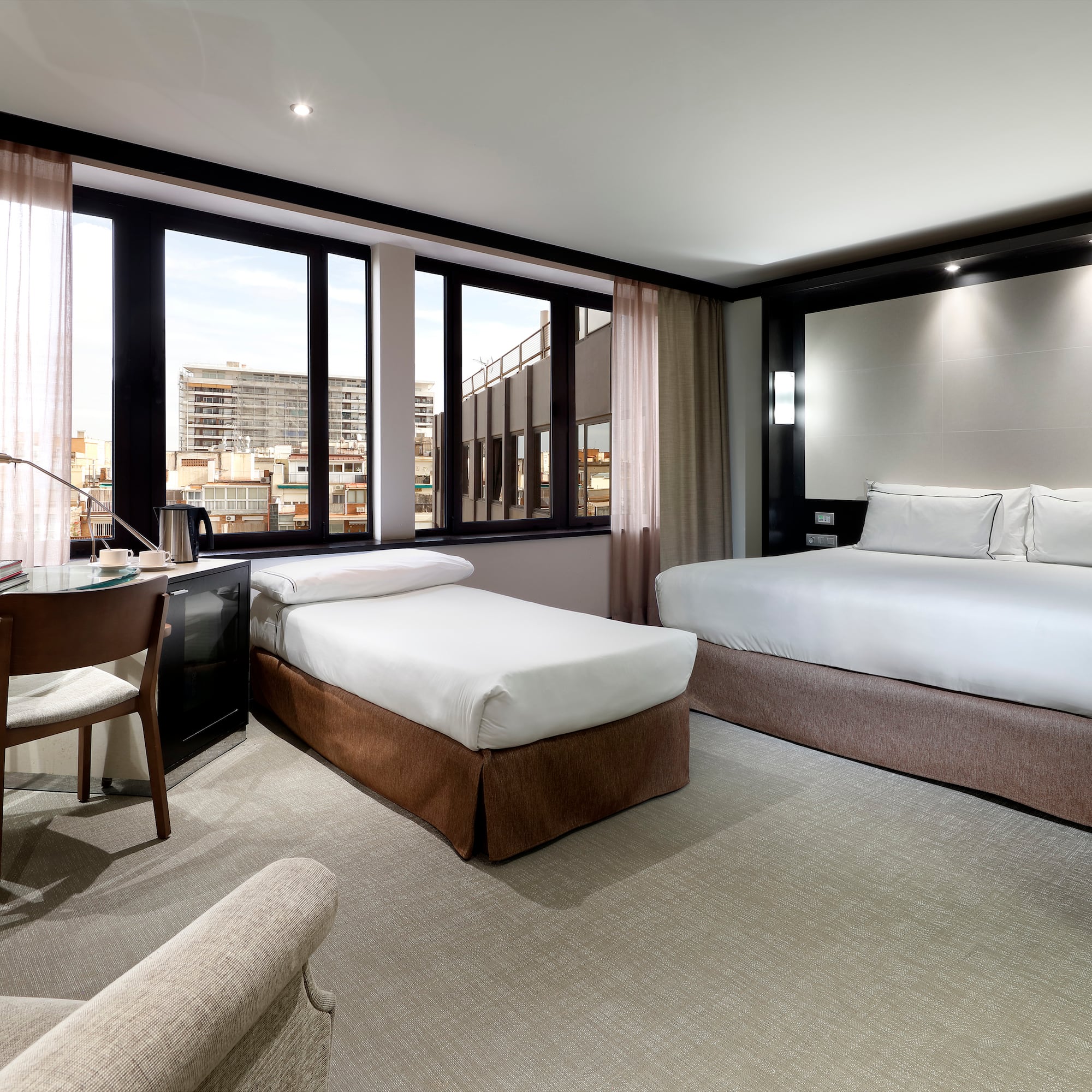 a room with two beds and a desk