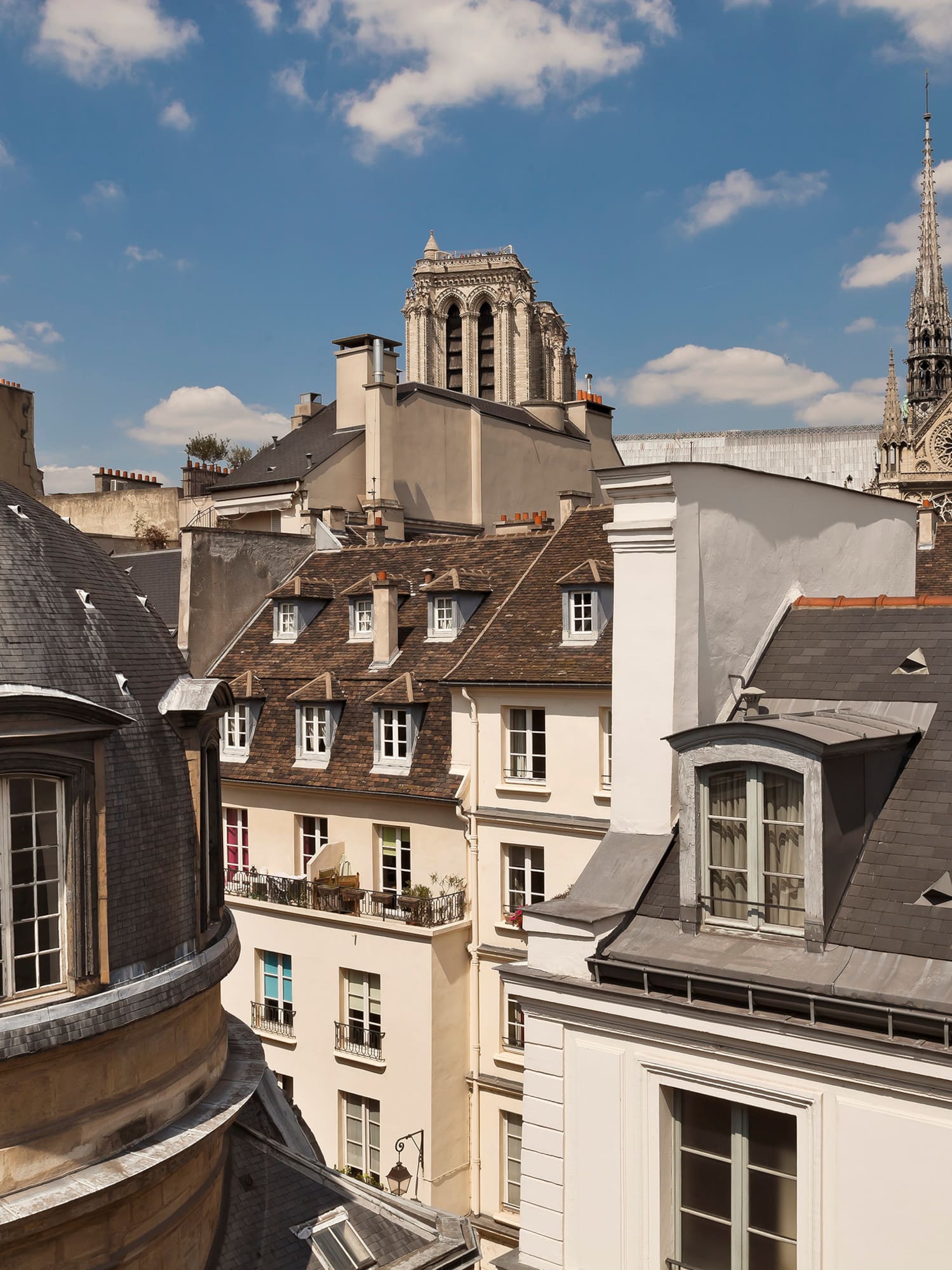 a rooftops of buildings with a steeple and a tower