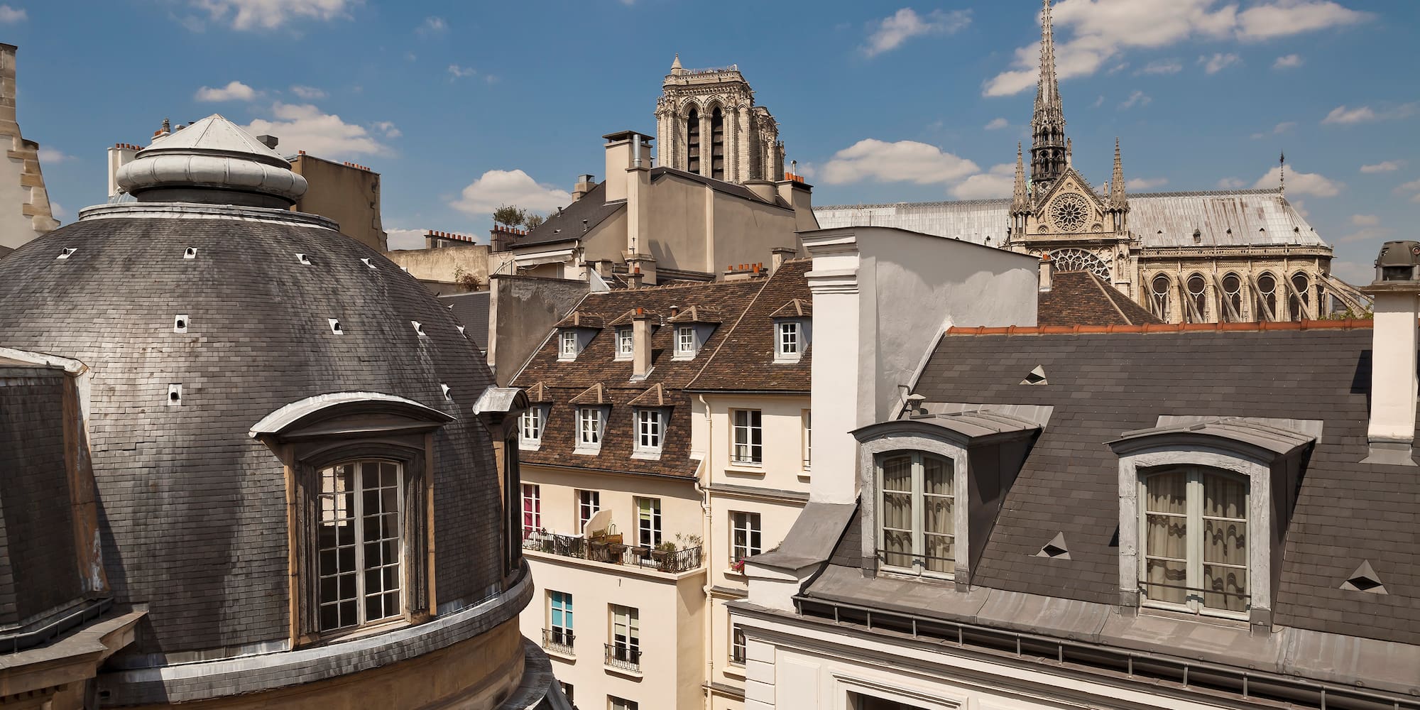 a rooftops of buildings with a steeple and a tower