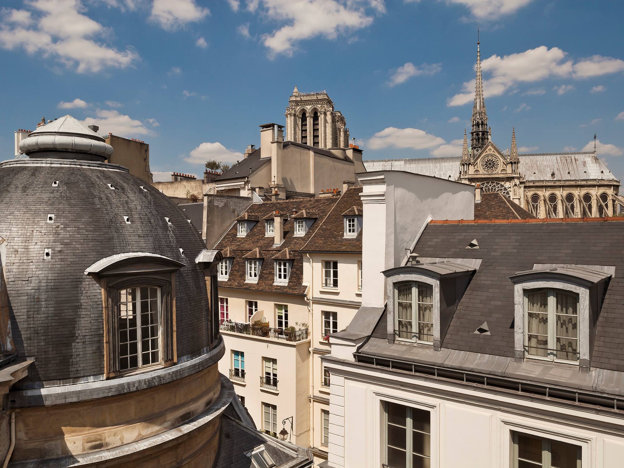 a rooftops of buildings with a steeple and a tower