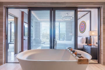 a bathtub in a room with glass doors