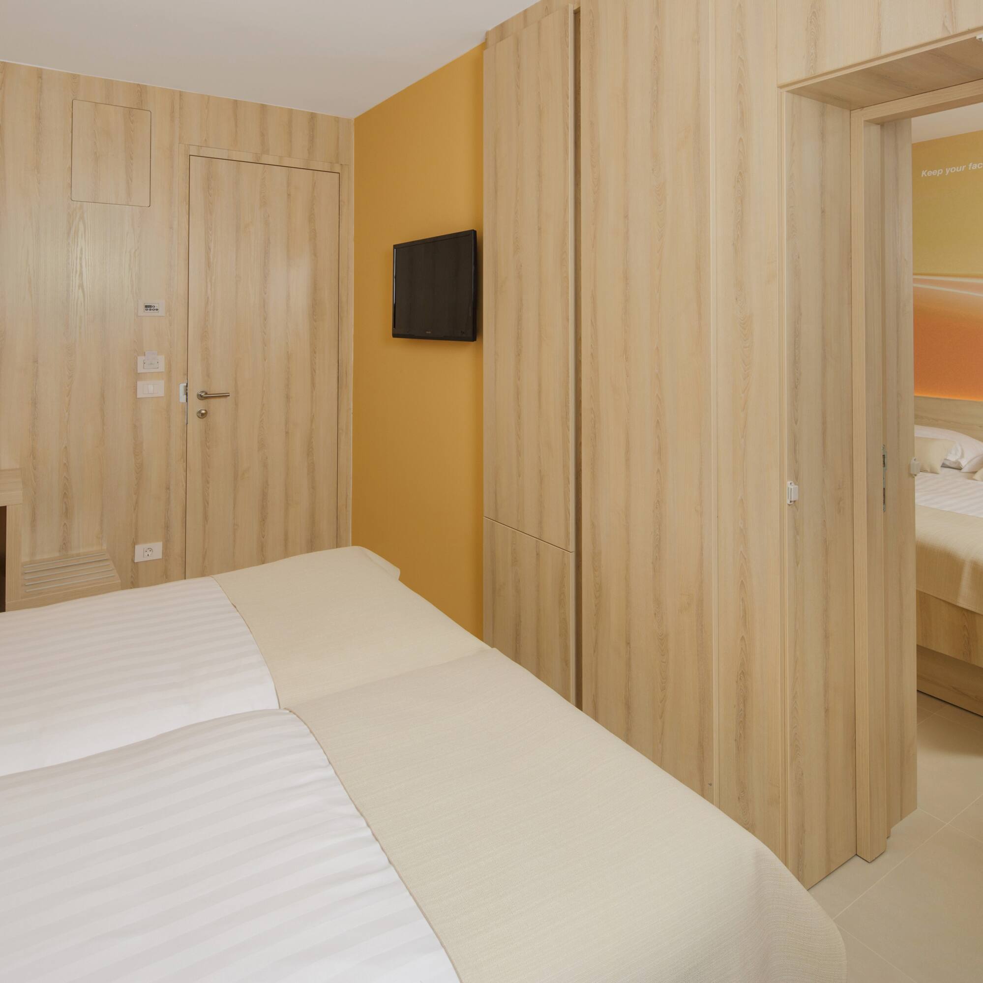 a room with a bed and a tv