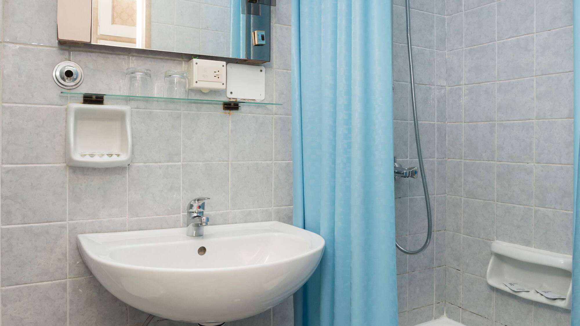 a bathroom with a sink and shower curtain