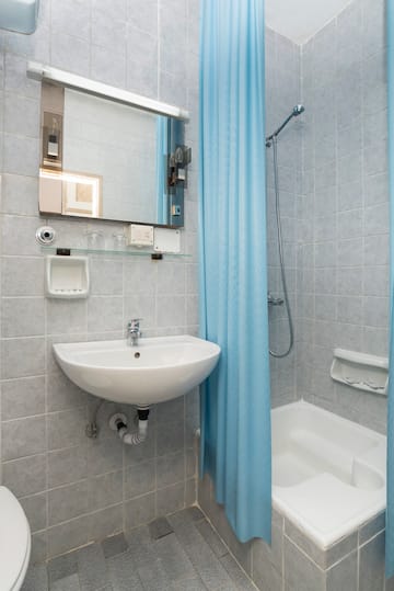 a bathroom with a sink and shower curtain