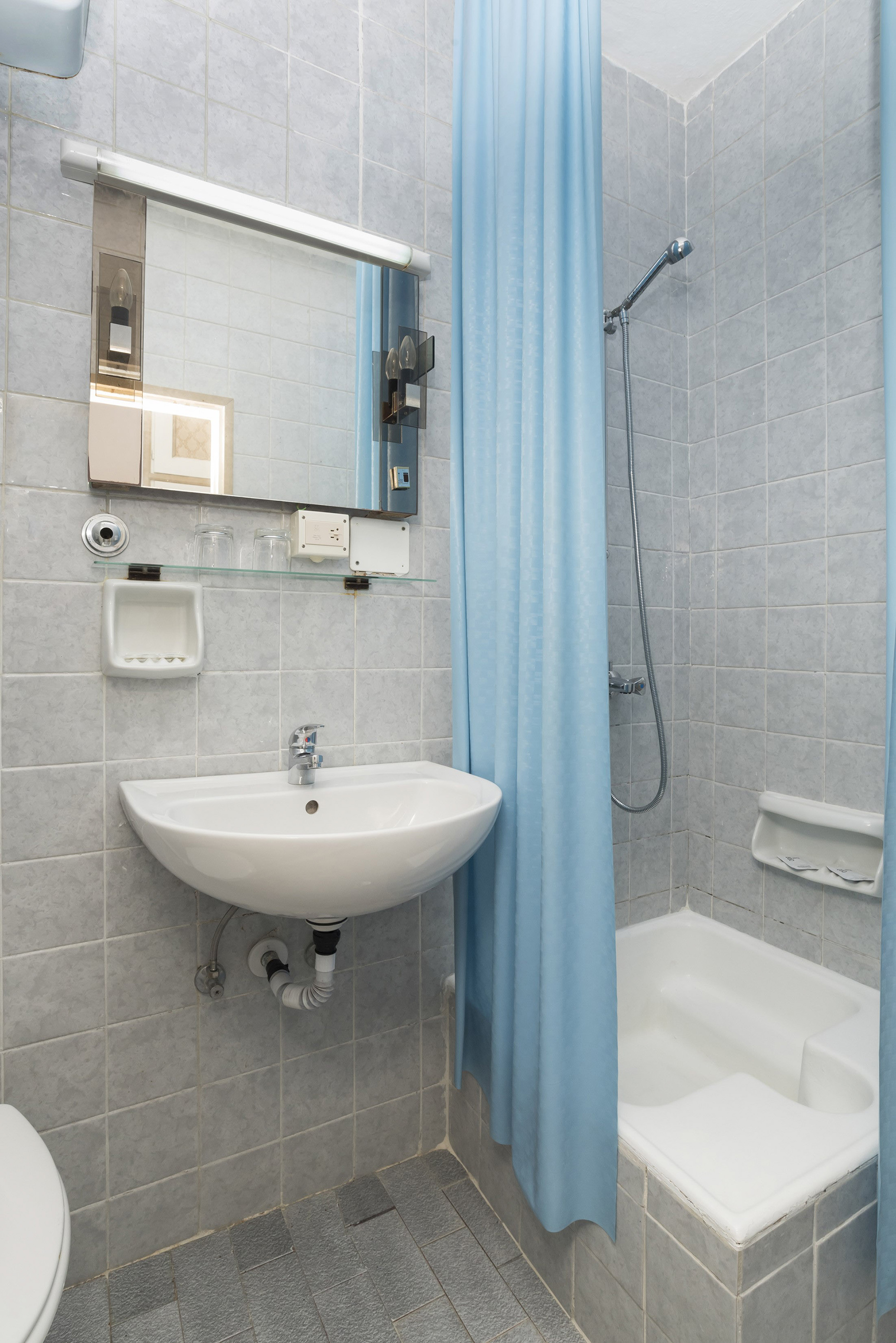 a bathroom with a sink and shower curtain