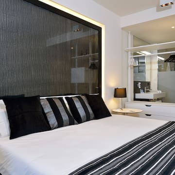 a bed with black and white pillows