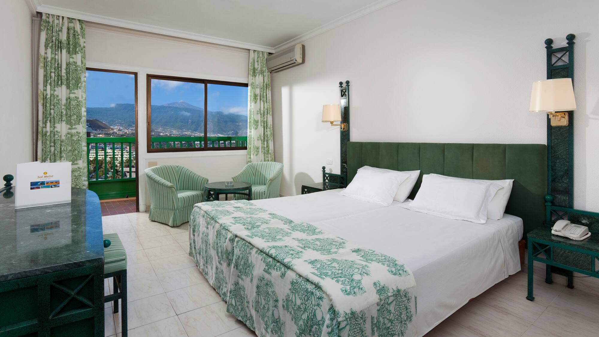 a bedroom with a bed and chairs