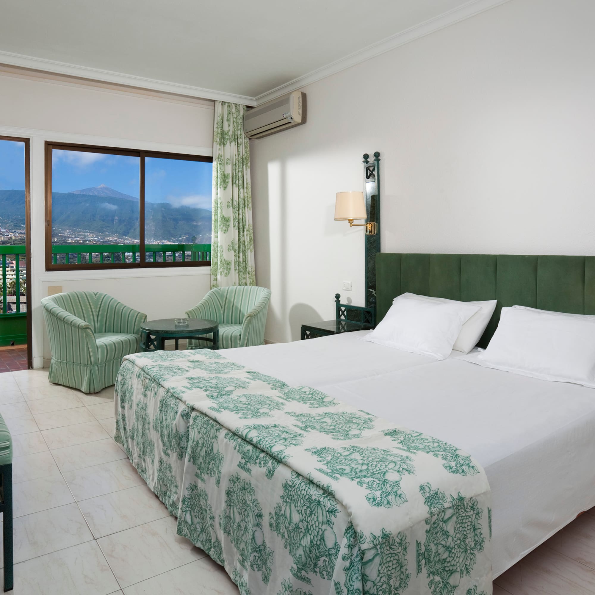 a bedroom with a bed and chairs