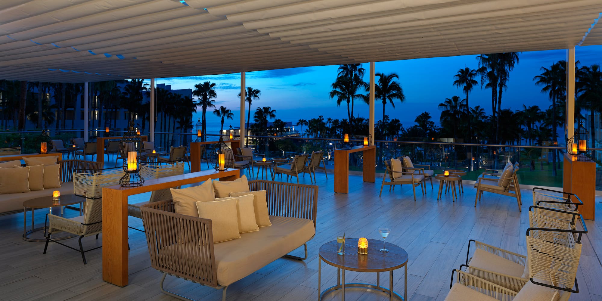 a room with a table and chairs and a table with candles