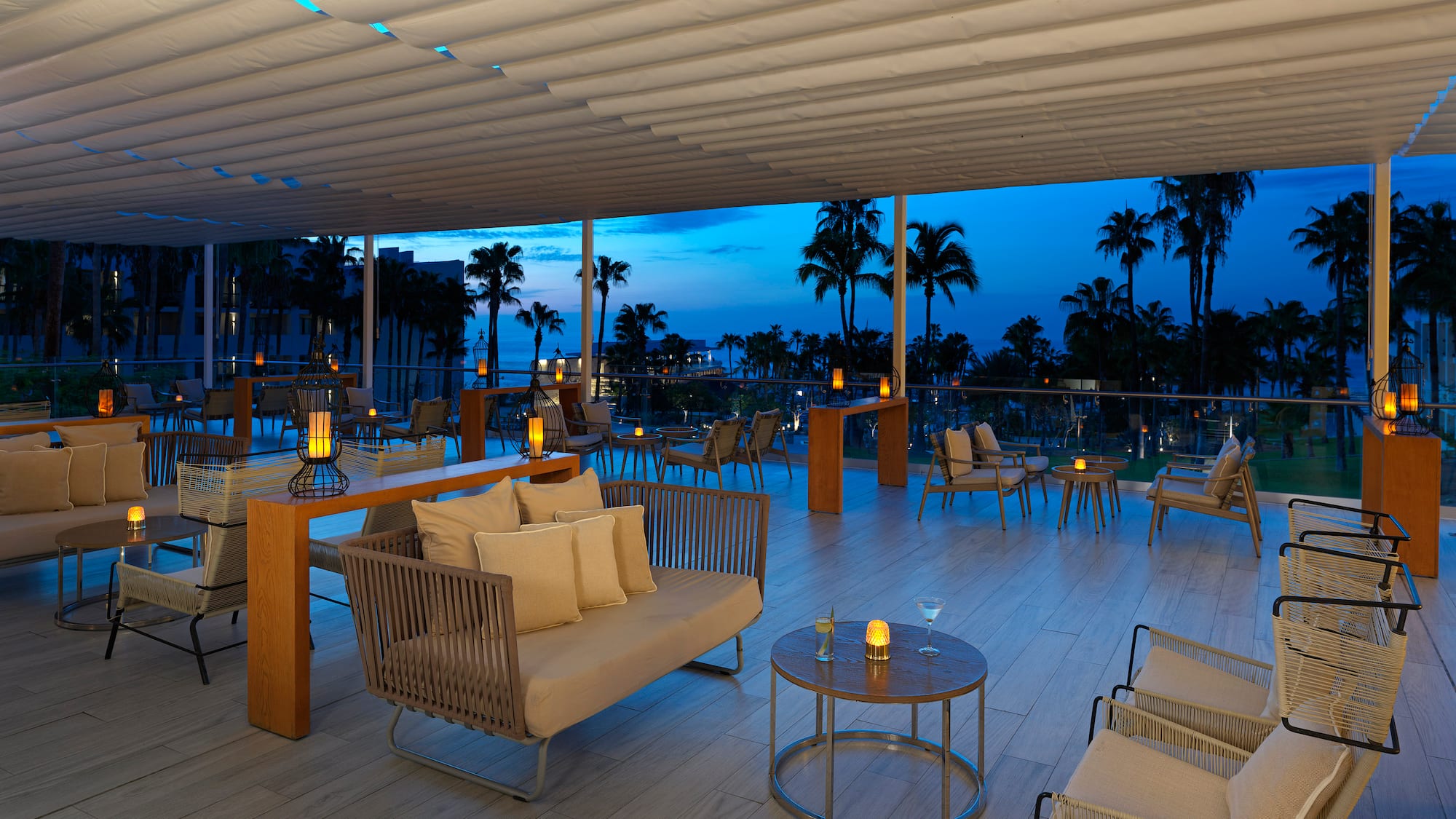 a room with a table and chairs and a table with candles