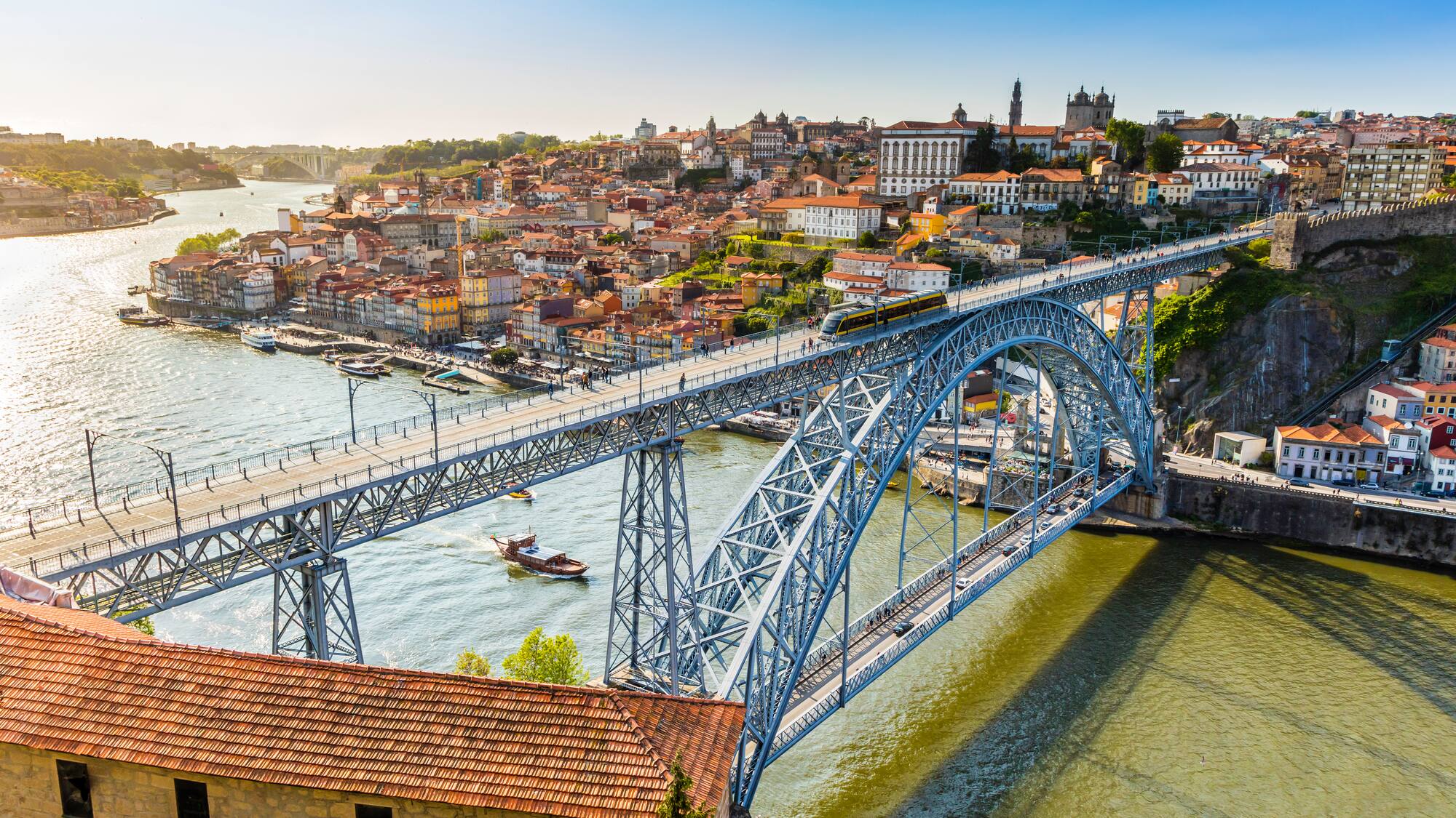 a bridge over a river with a city in the background