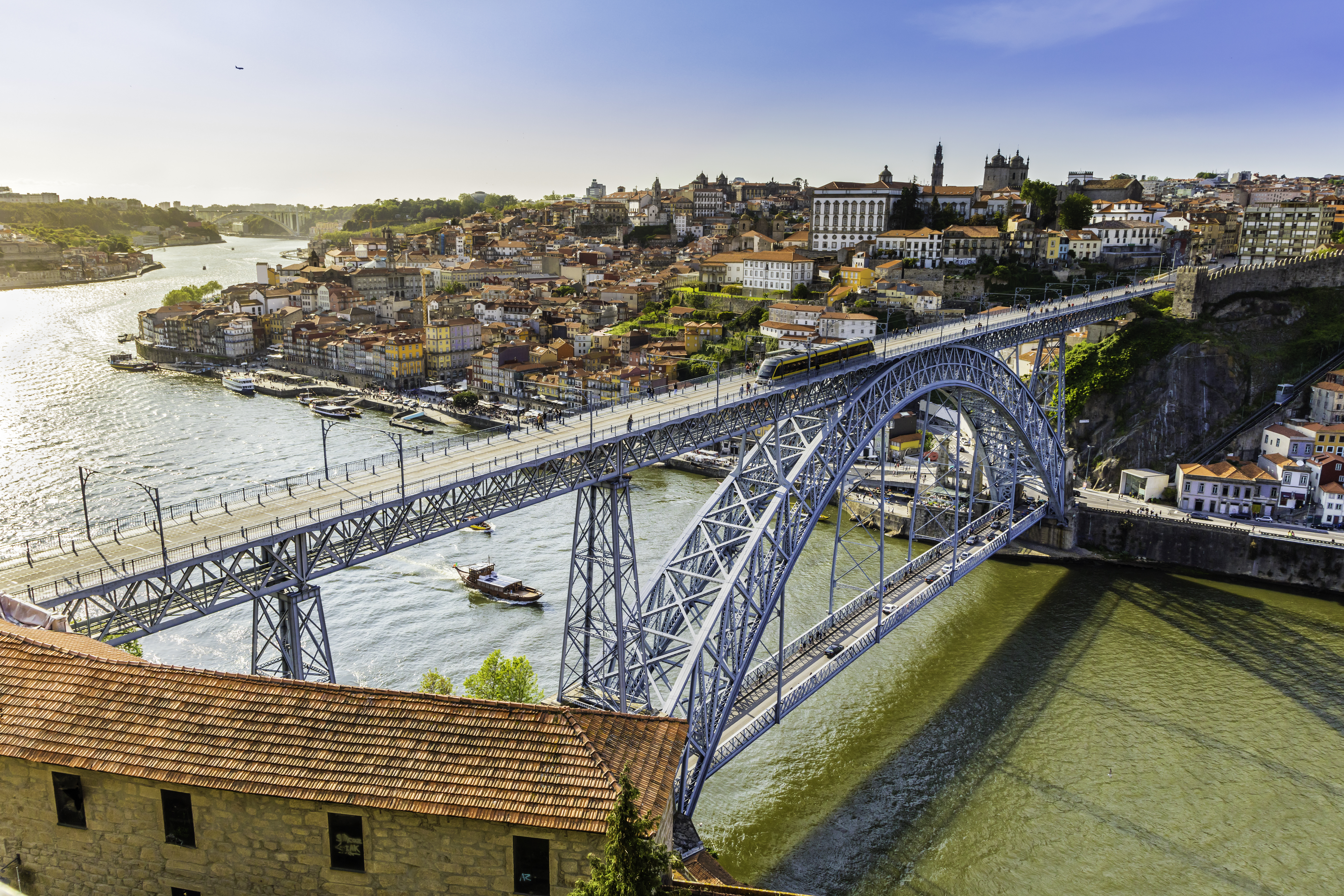 a bridge over a river with a city in the background