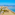 a beach with palm trees and buildings