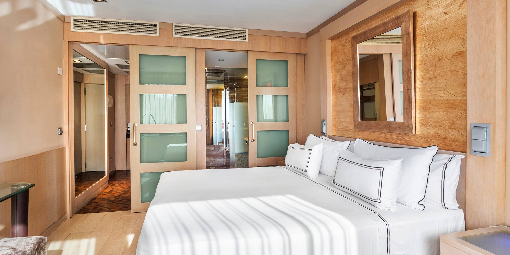 a bedroom with a bed and a mirror