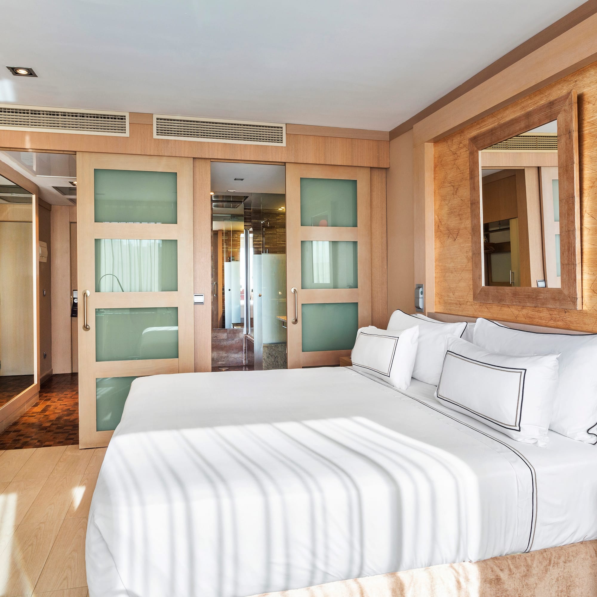 a bedroom with a bed and a mirror