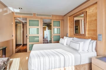 a bedroom with a bed and a mirror