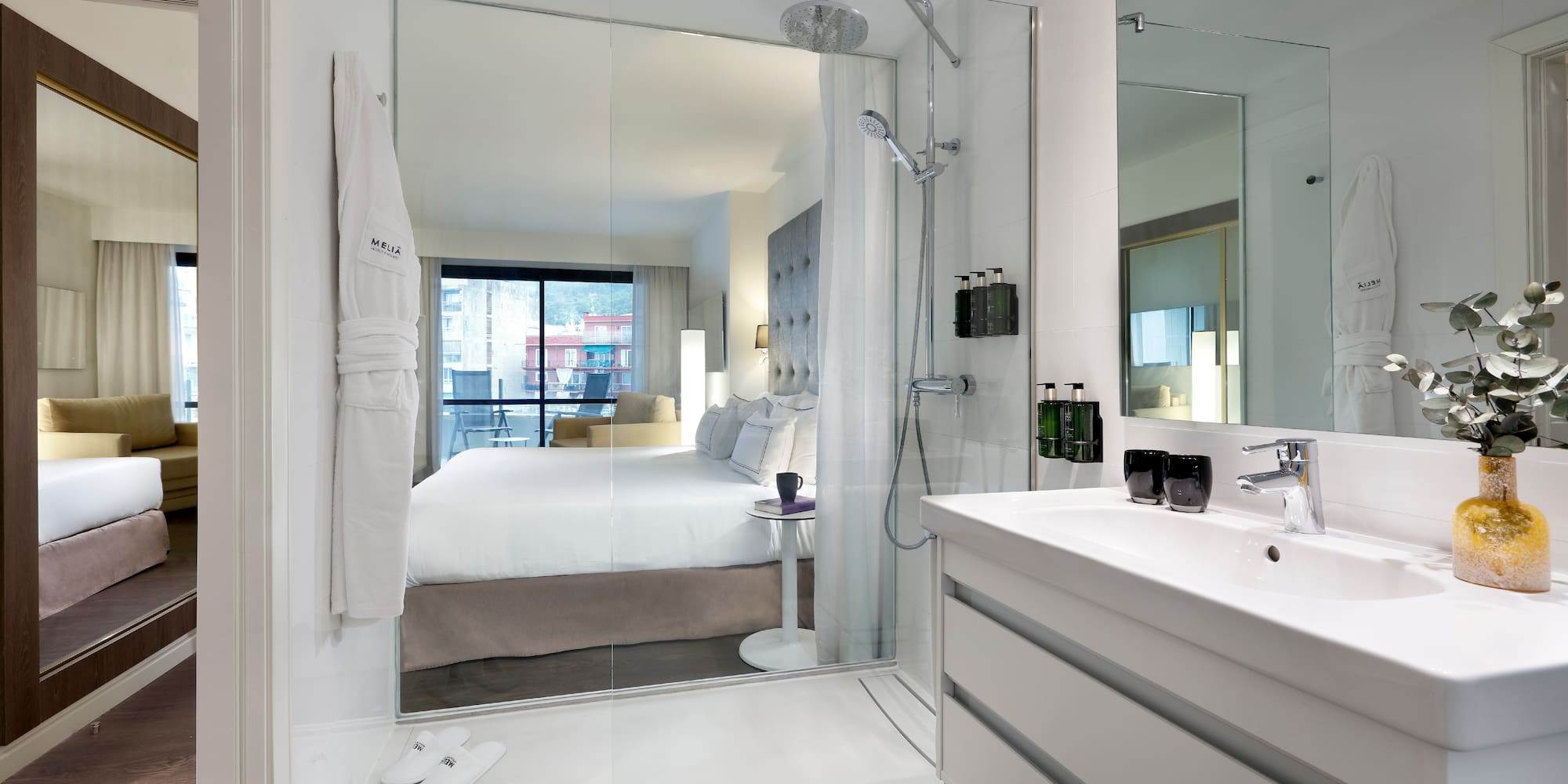 a bathroom with a large mirror and a bed
