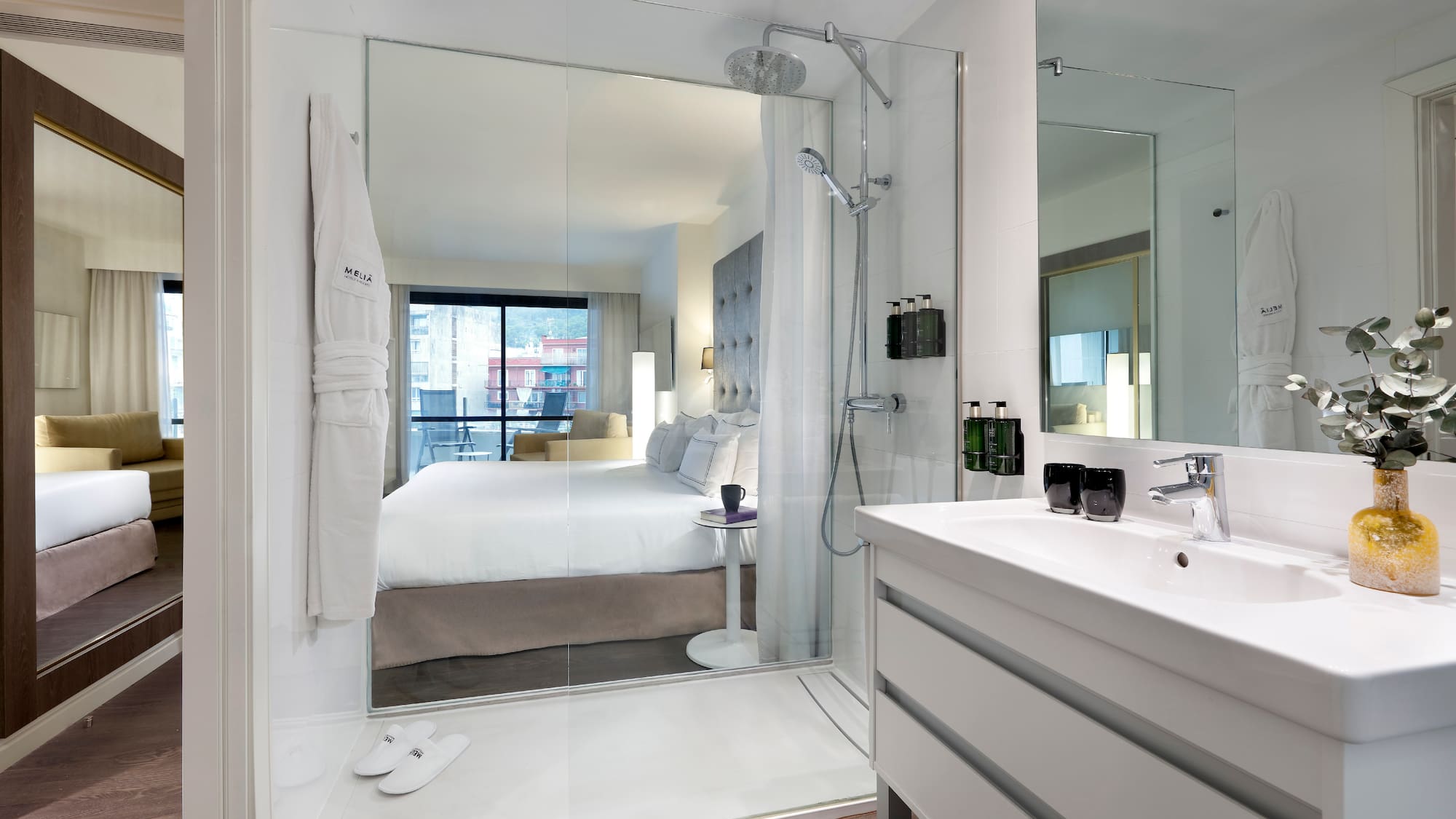 a bathroom with a large mirror and a bed