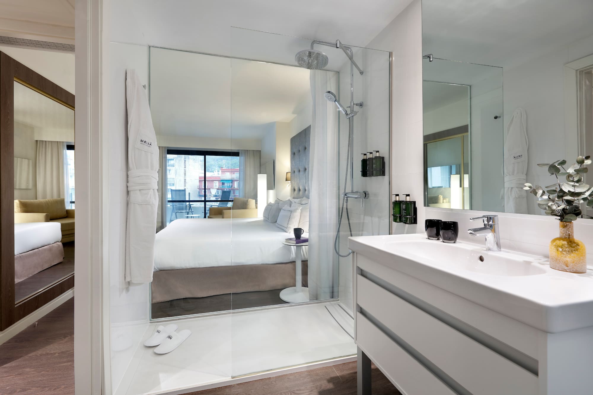 a bathroom with a large mirror and a bed