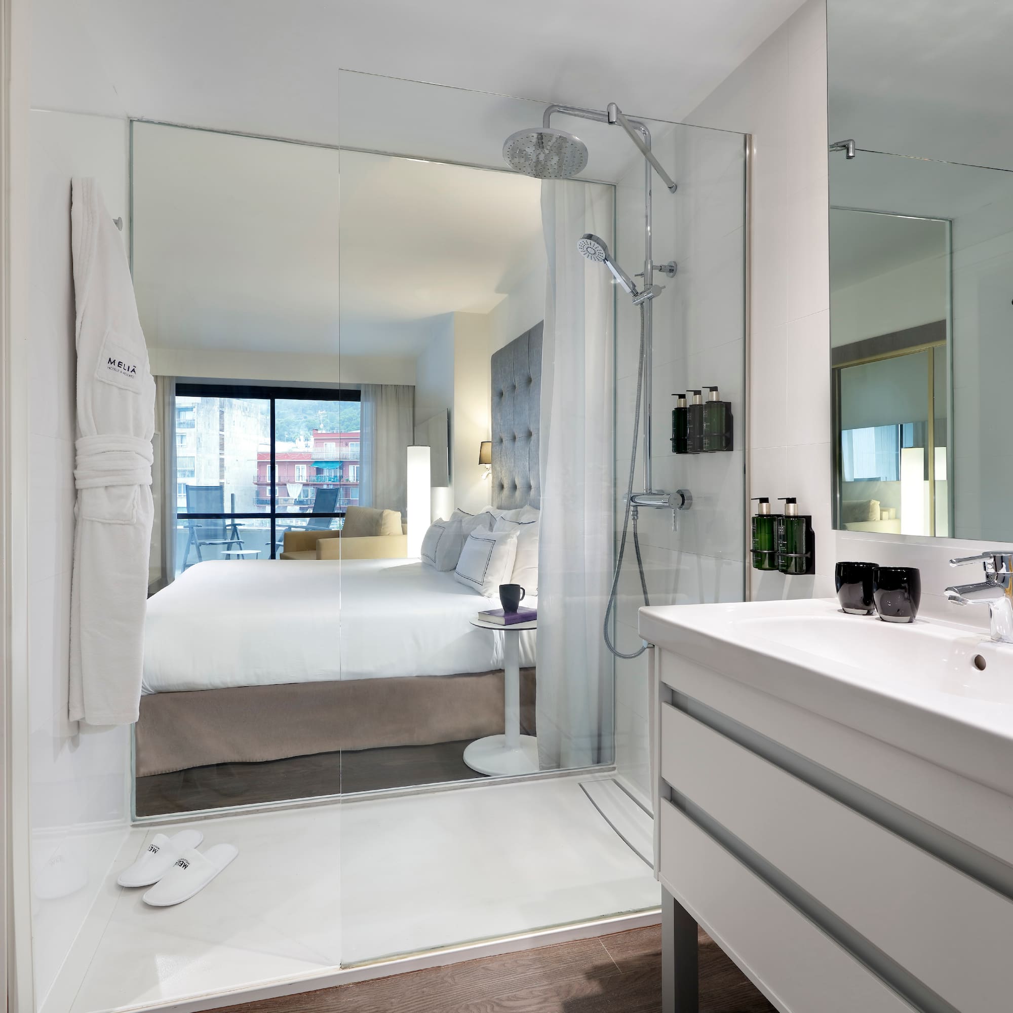 a bathroom with a large mirror and a bed