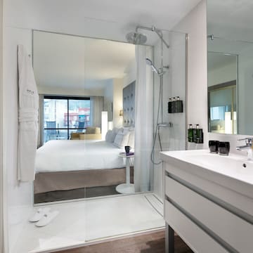a bathroom with a large mirror and a bed