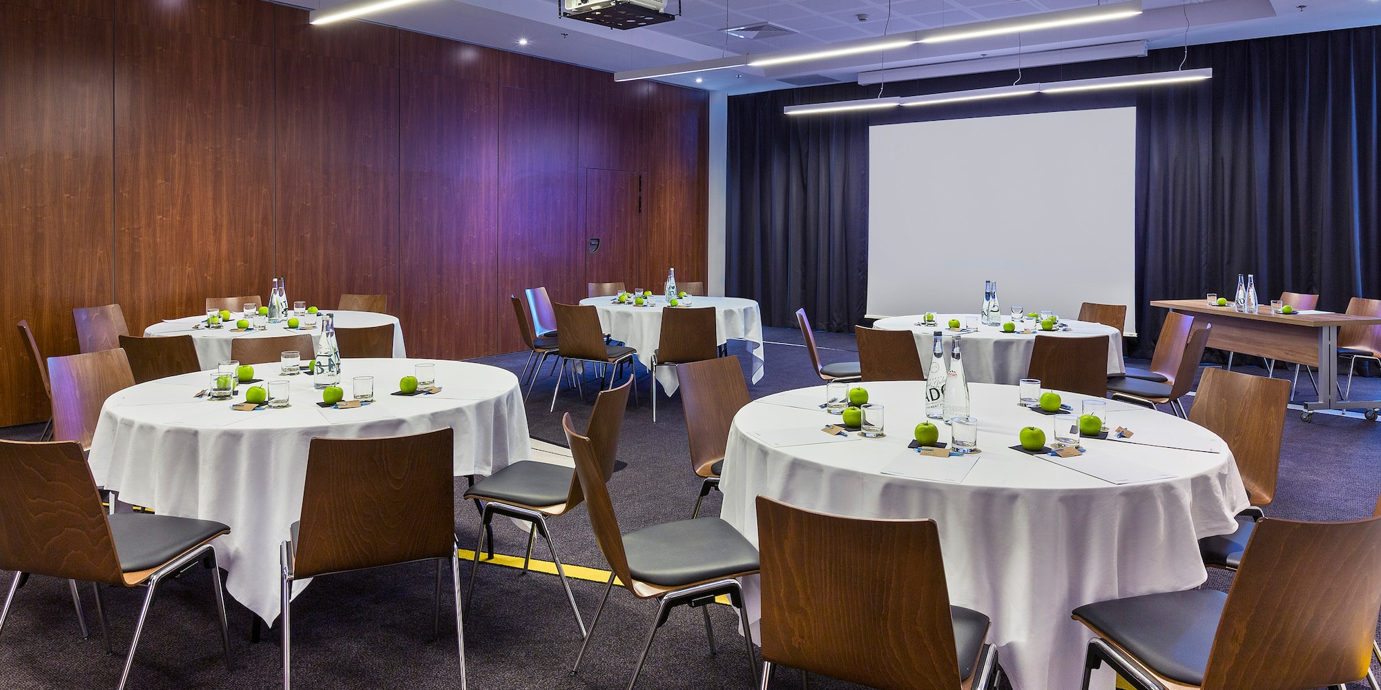 a room with round tables and chairs