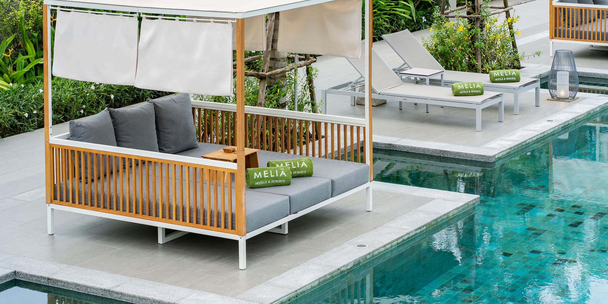 a pool with a couch and chairs