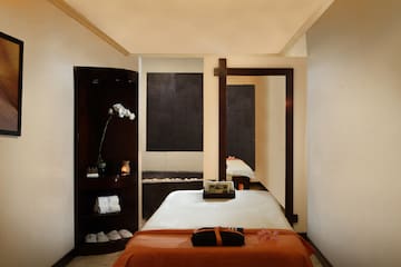 a room with a bed and a mirror