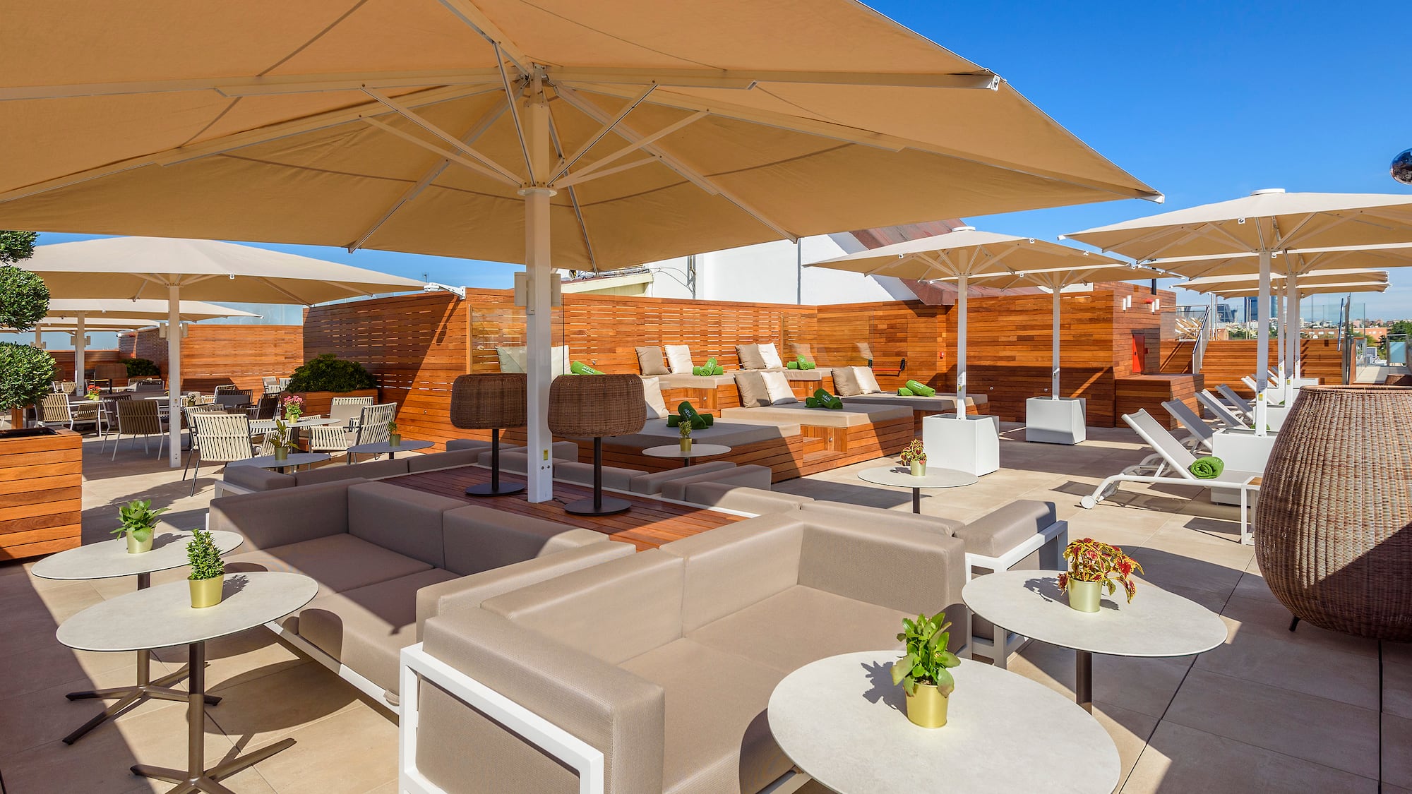 a patio with chairs and tables and umbrellas