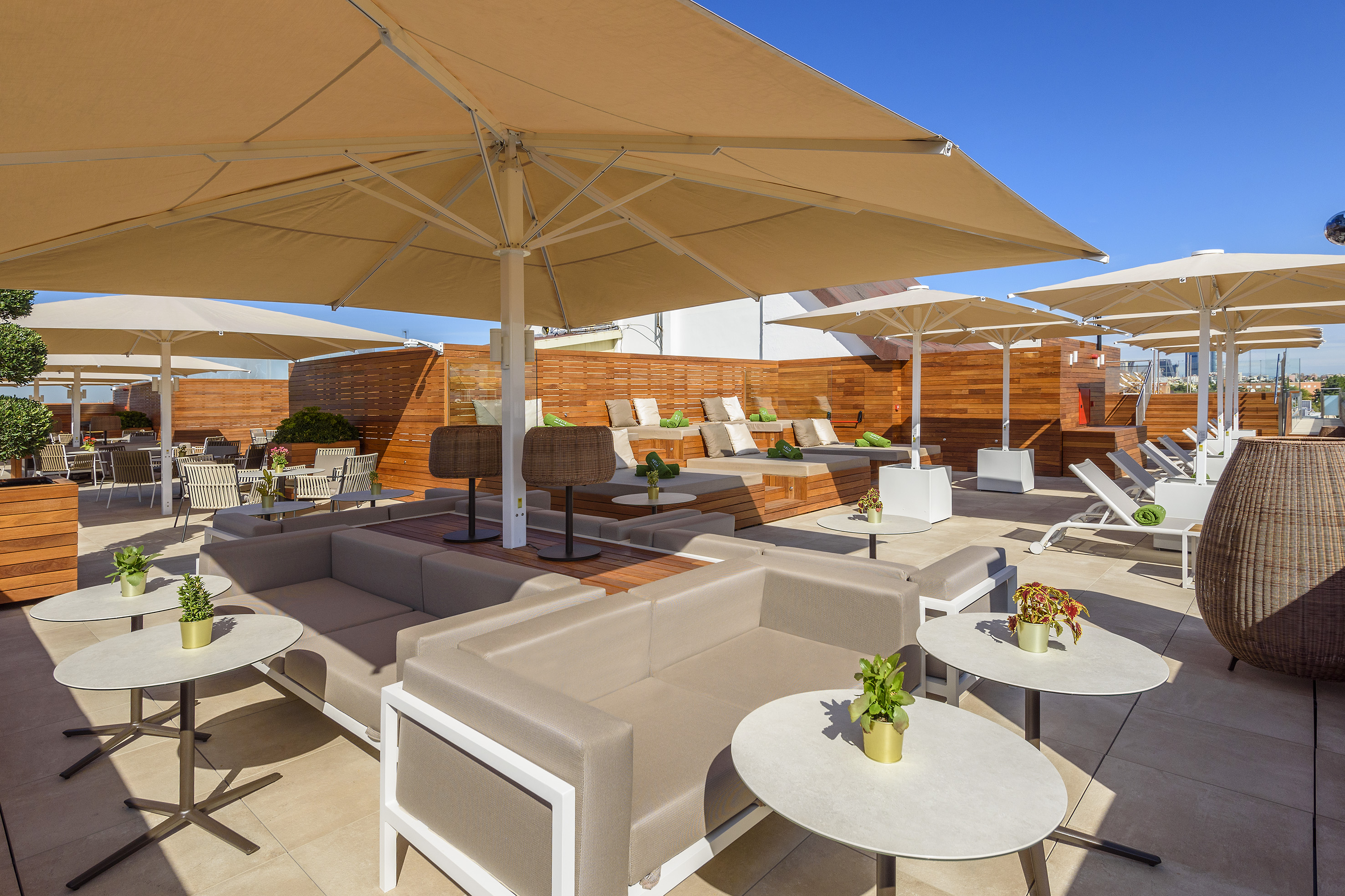 a patio with chairs and tables and umbrellas