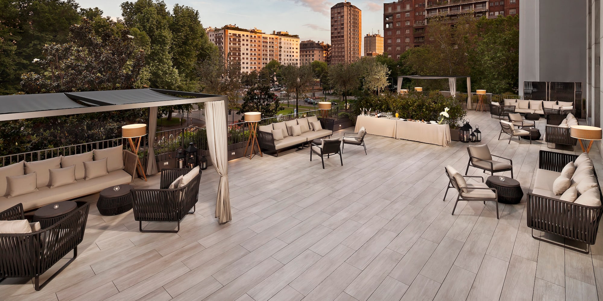 a patio with chairs and tables and trees