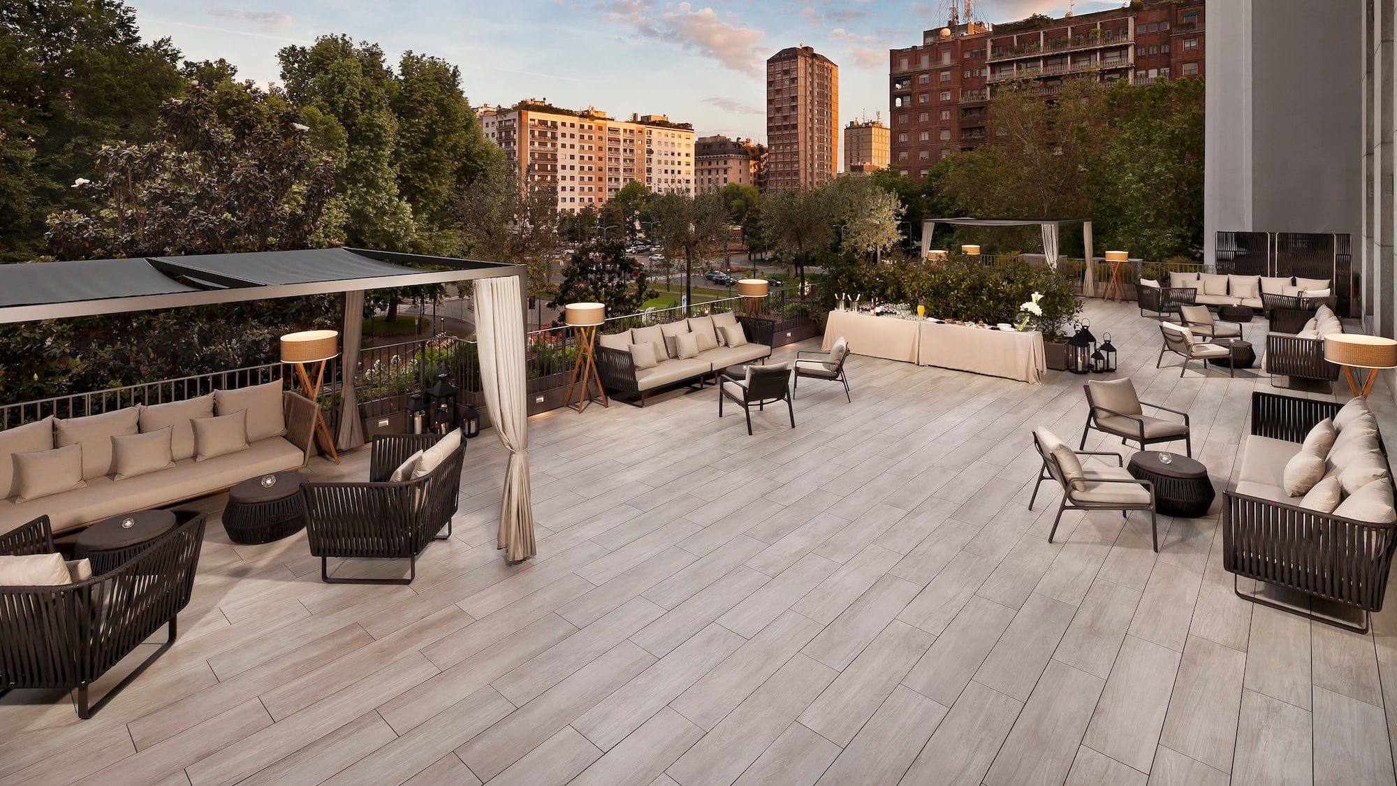 a patio with chairs and tables and trees