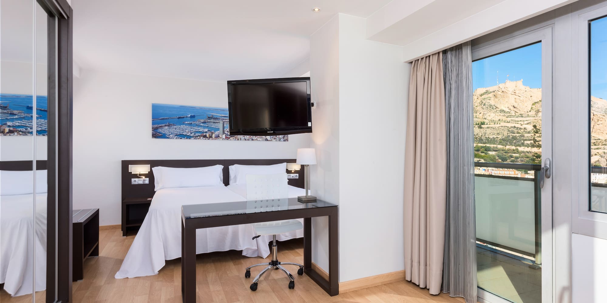 a room with a bed and a desk