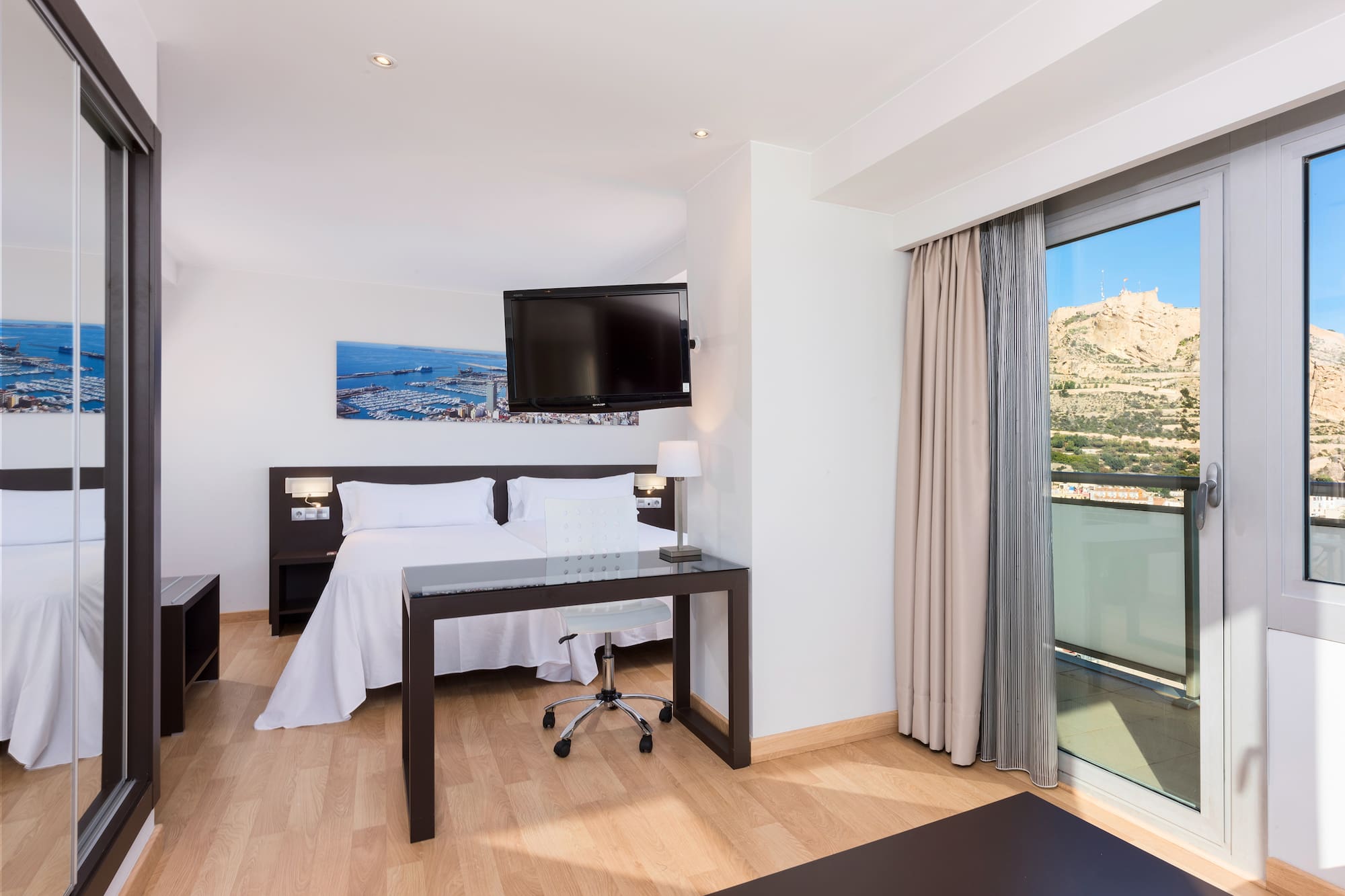 a room with a bed and a desk