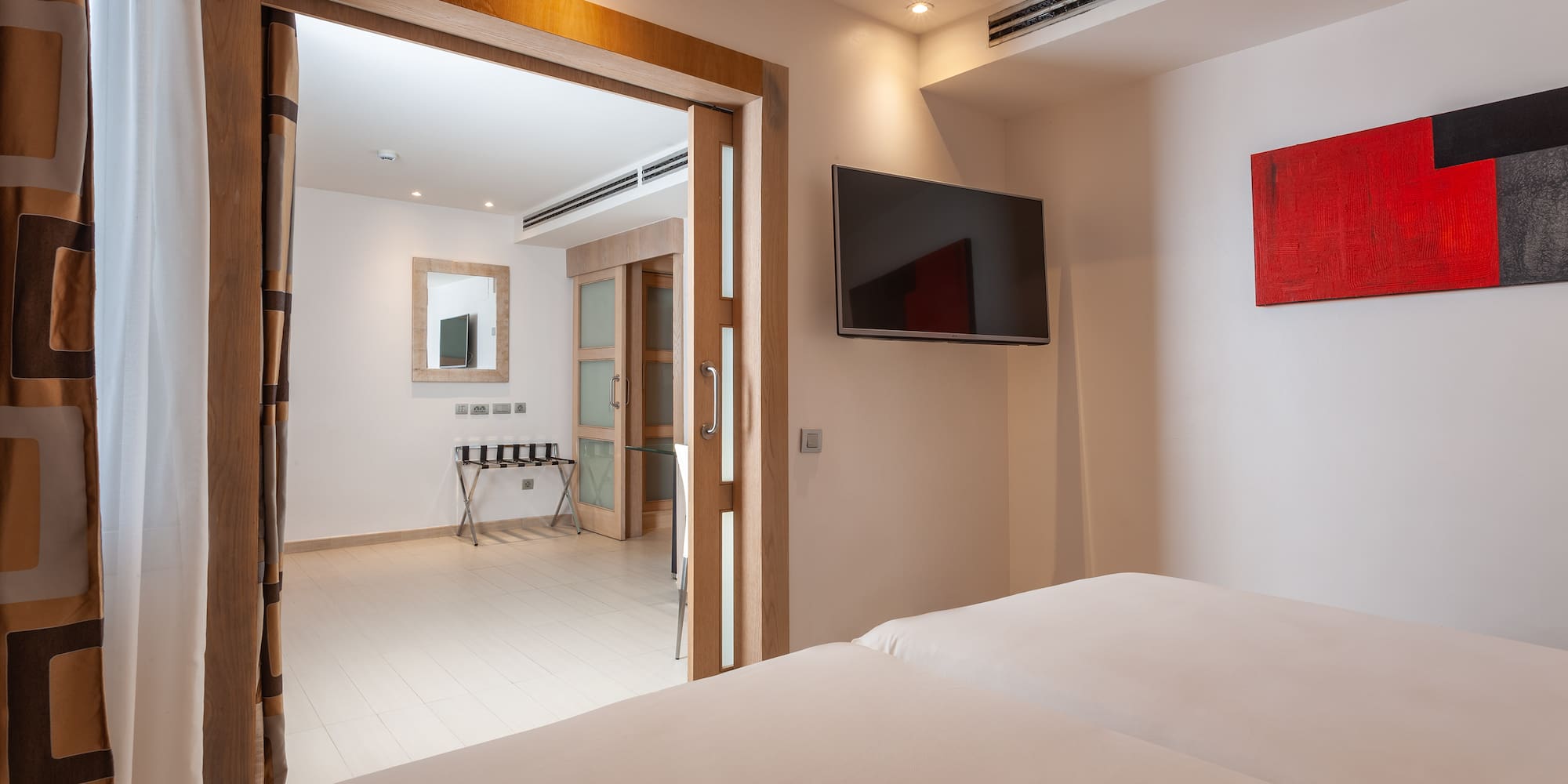 a room with a tv and a bed