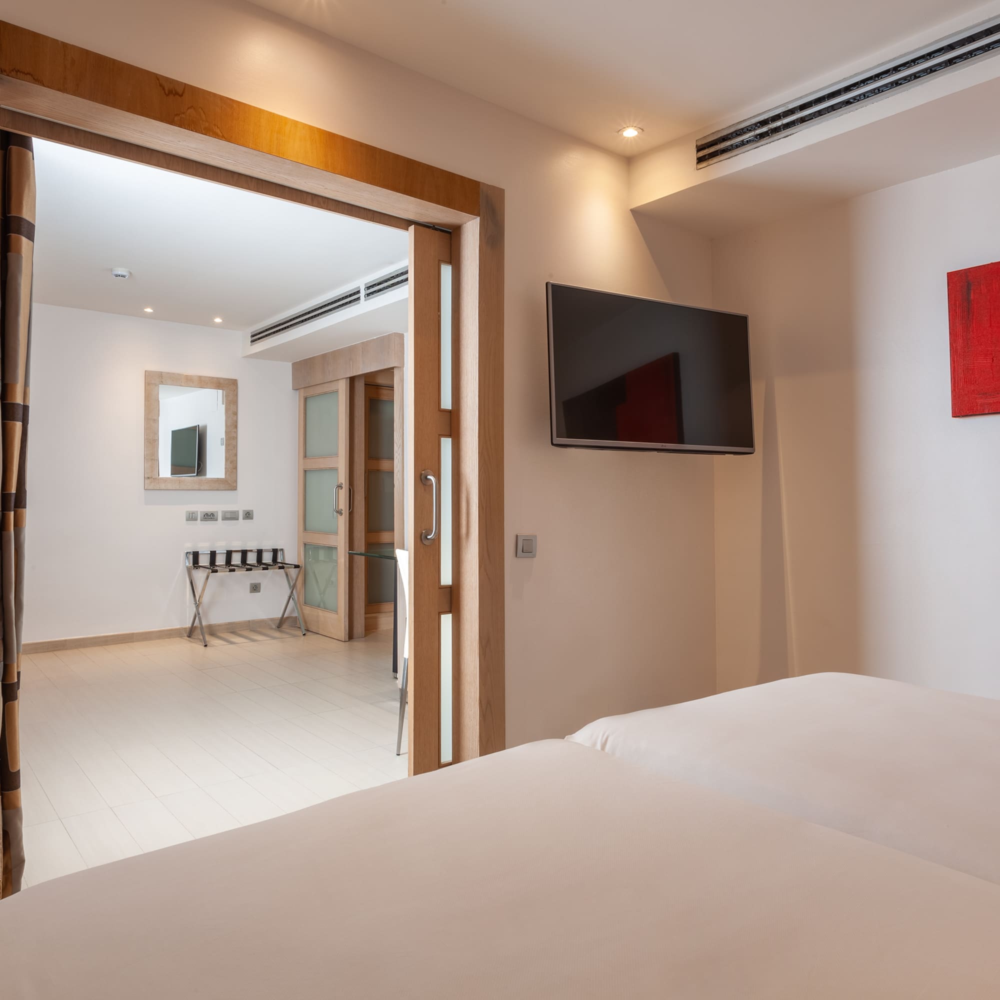 a room with a tv and a bed