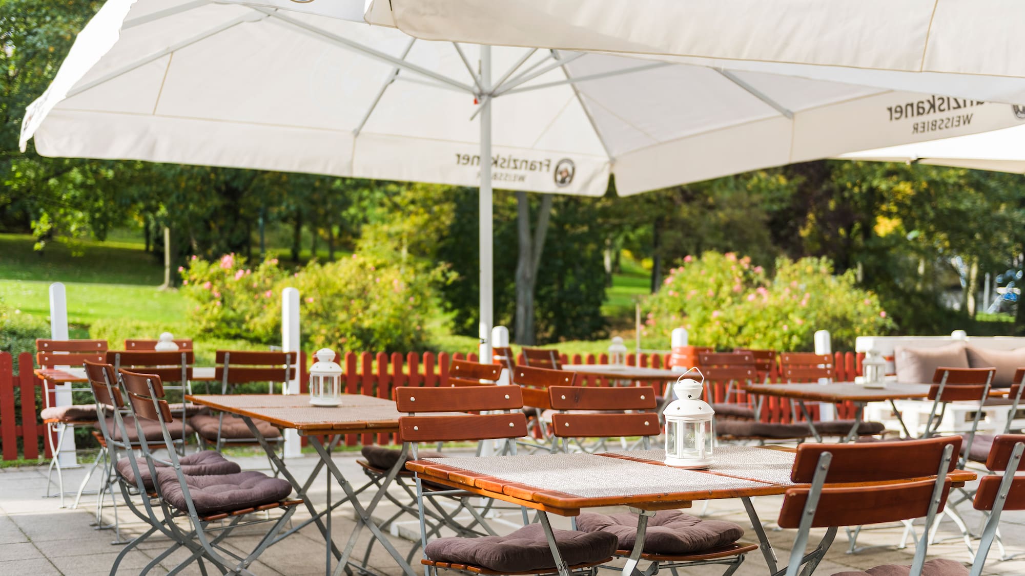 tables and chairs under umbrellas