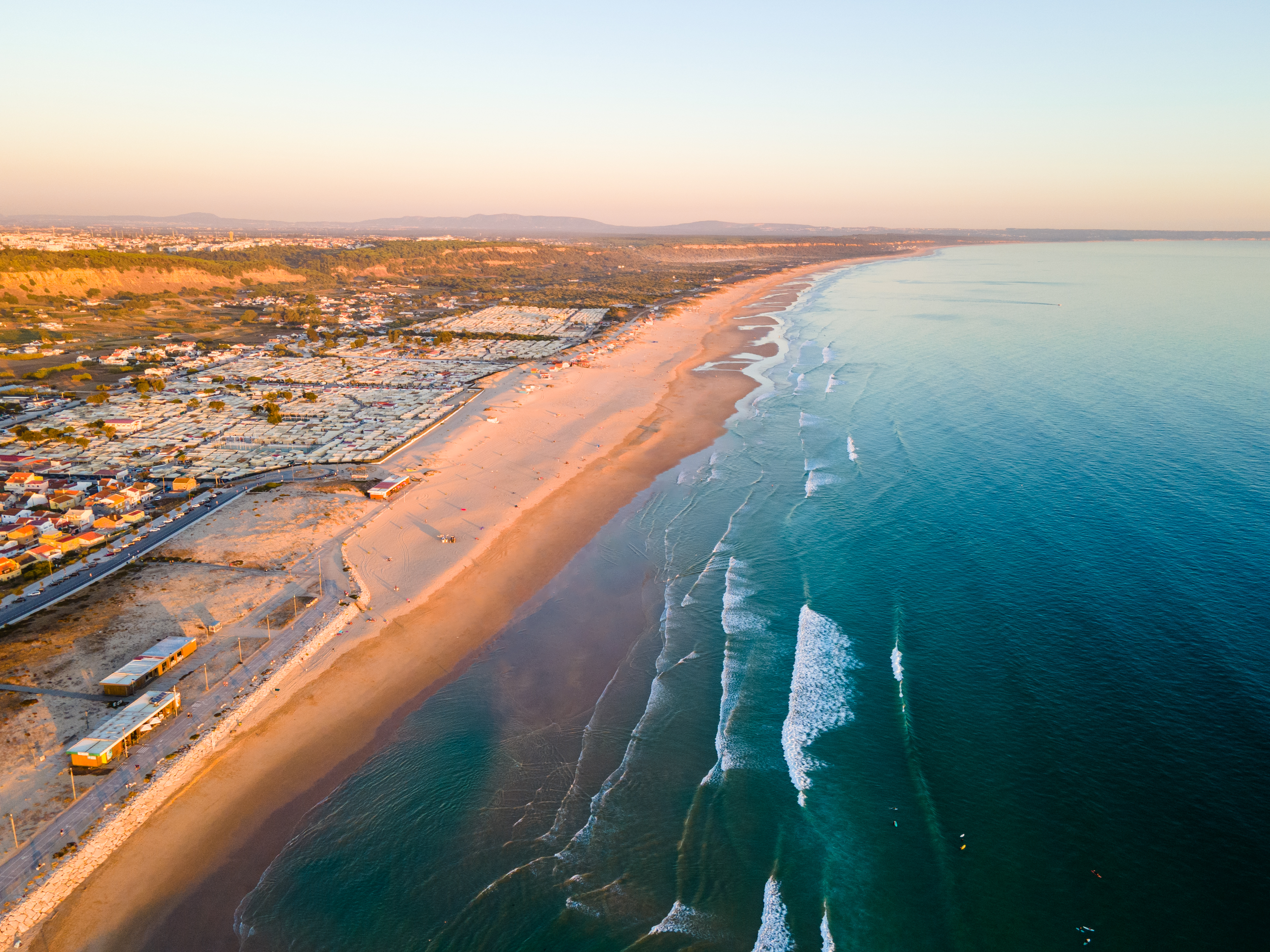 a beach with buildings and water