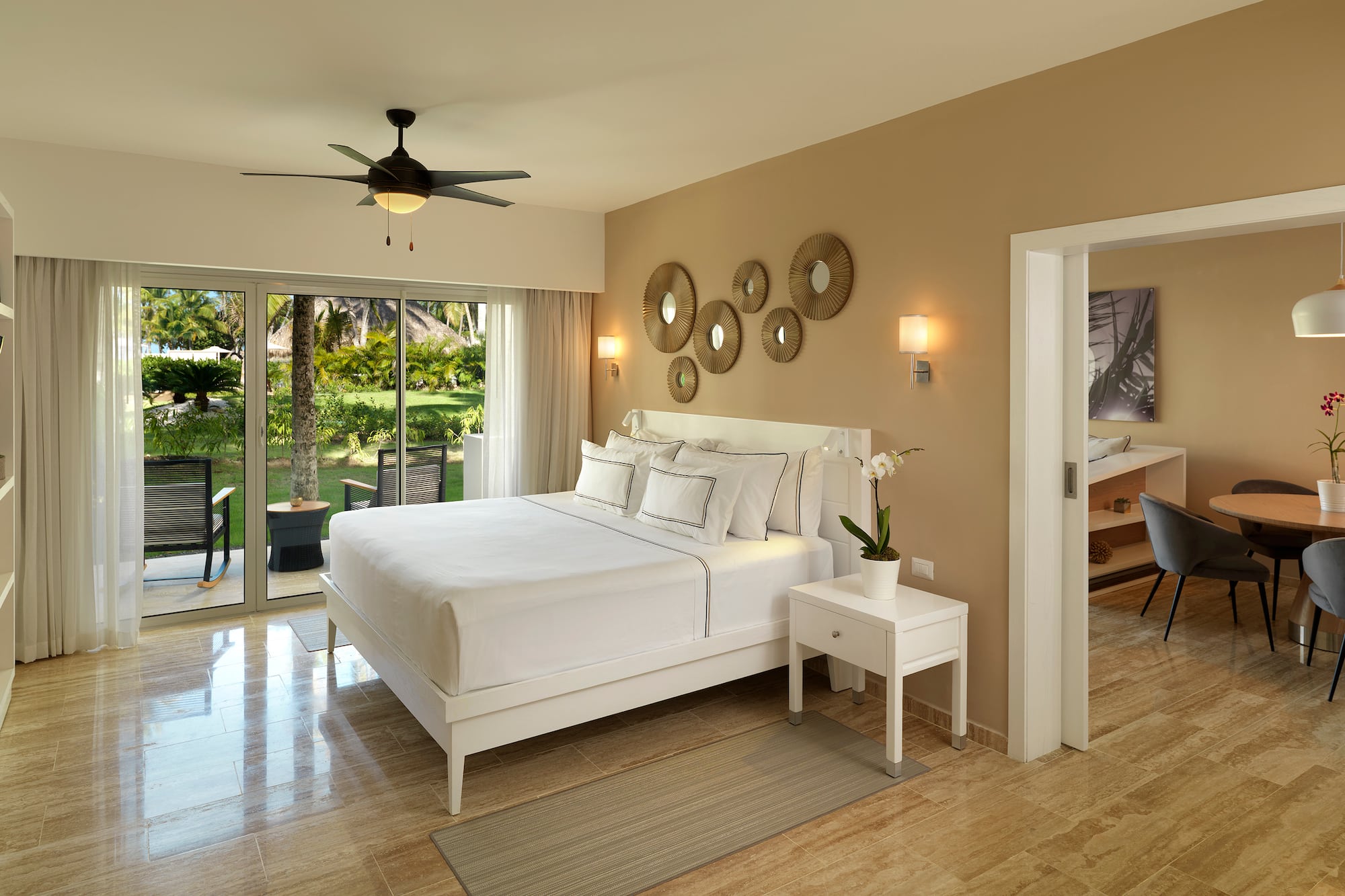 a bedroom with a ceiling fan and a bed.