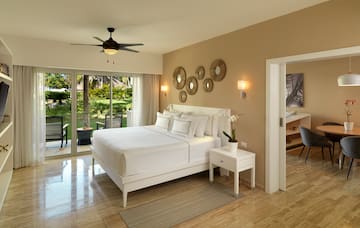 a bedroom with a ceiling fan and a bed.