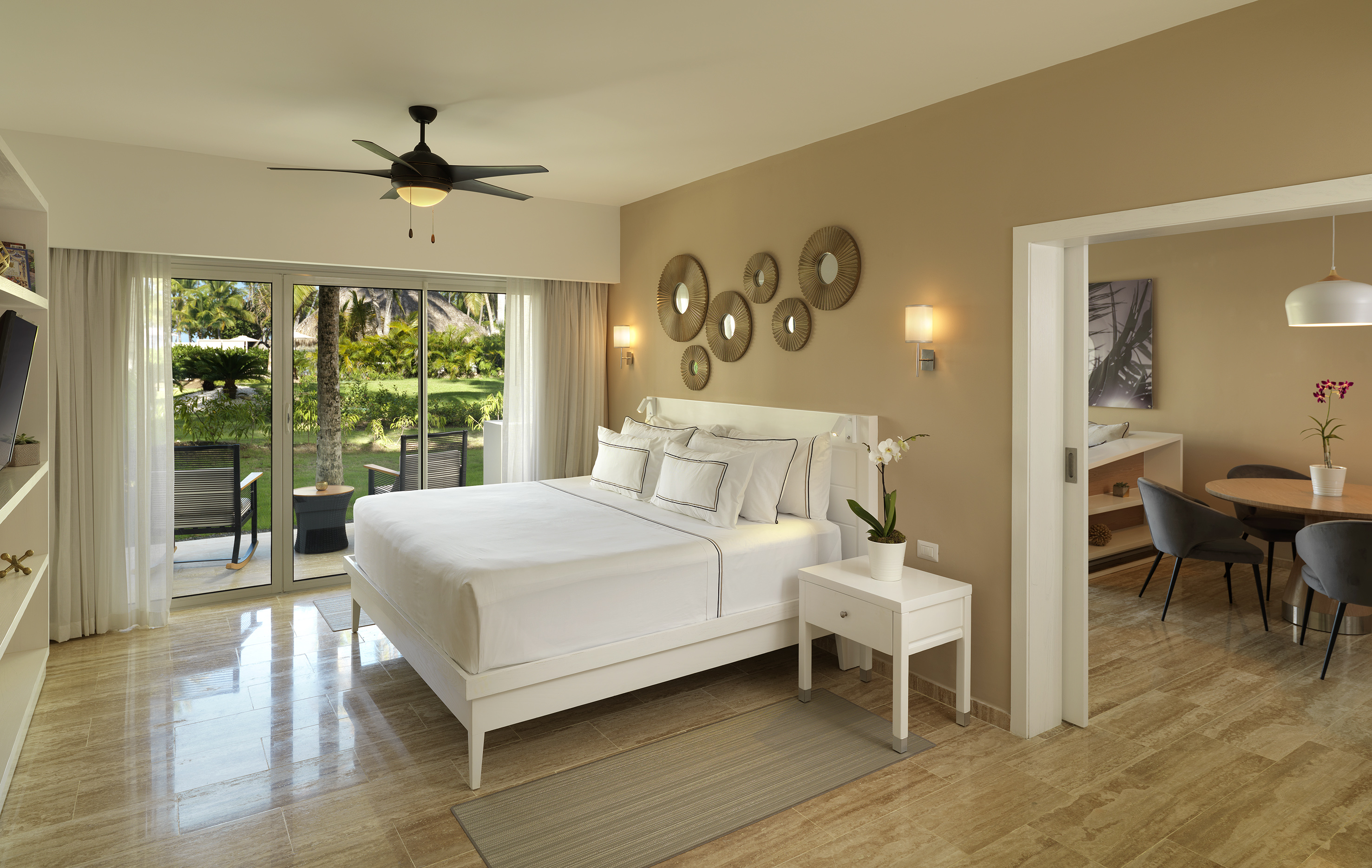 a bedroom with a ceiling fan and a bed.